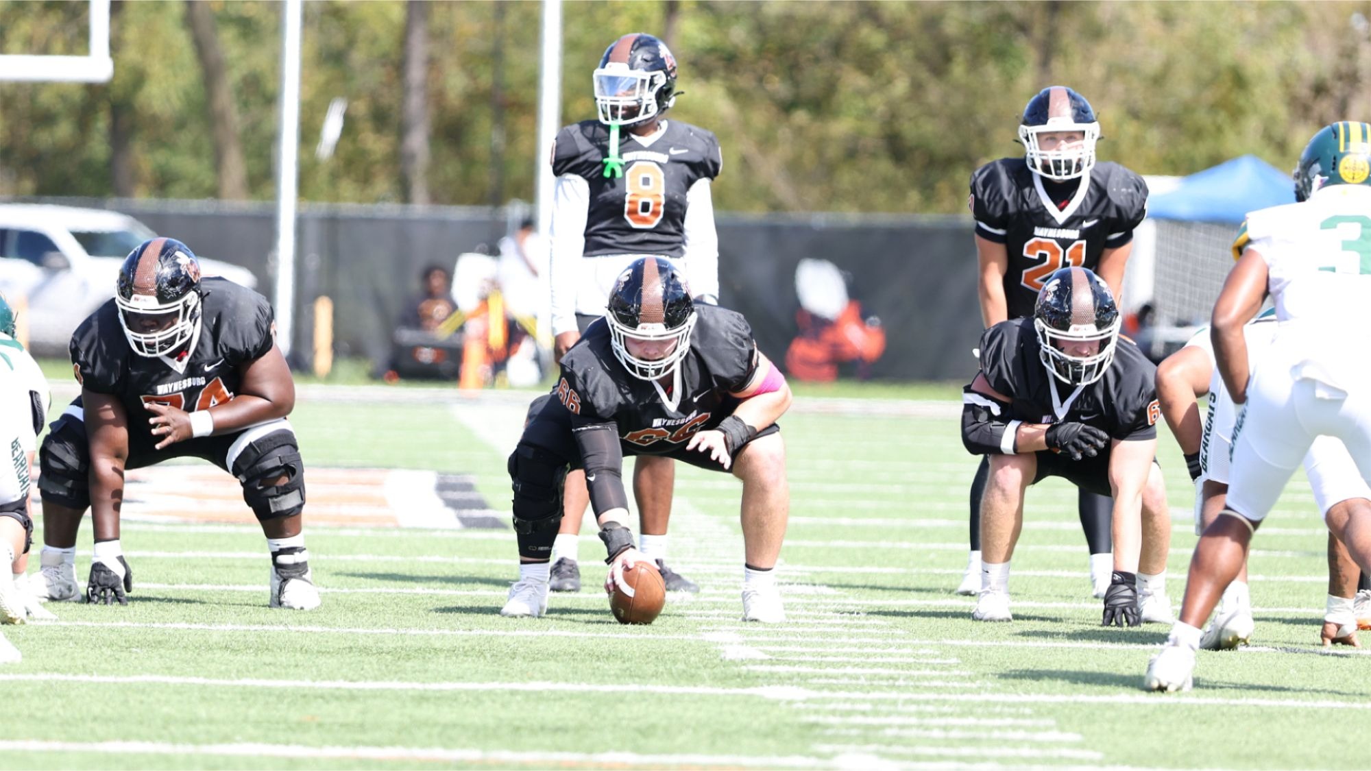 The Waynesburg University offensive line lines up to snap the football against Saint Vincent