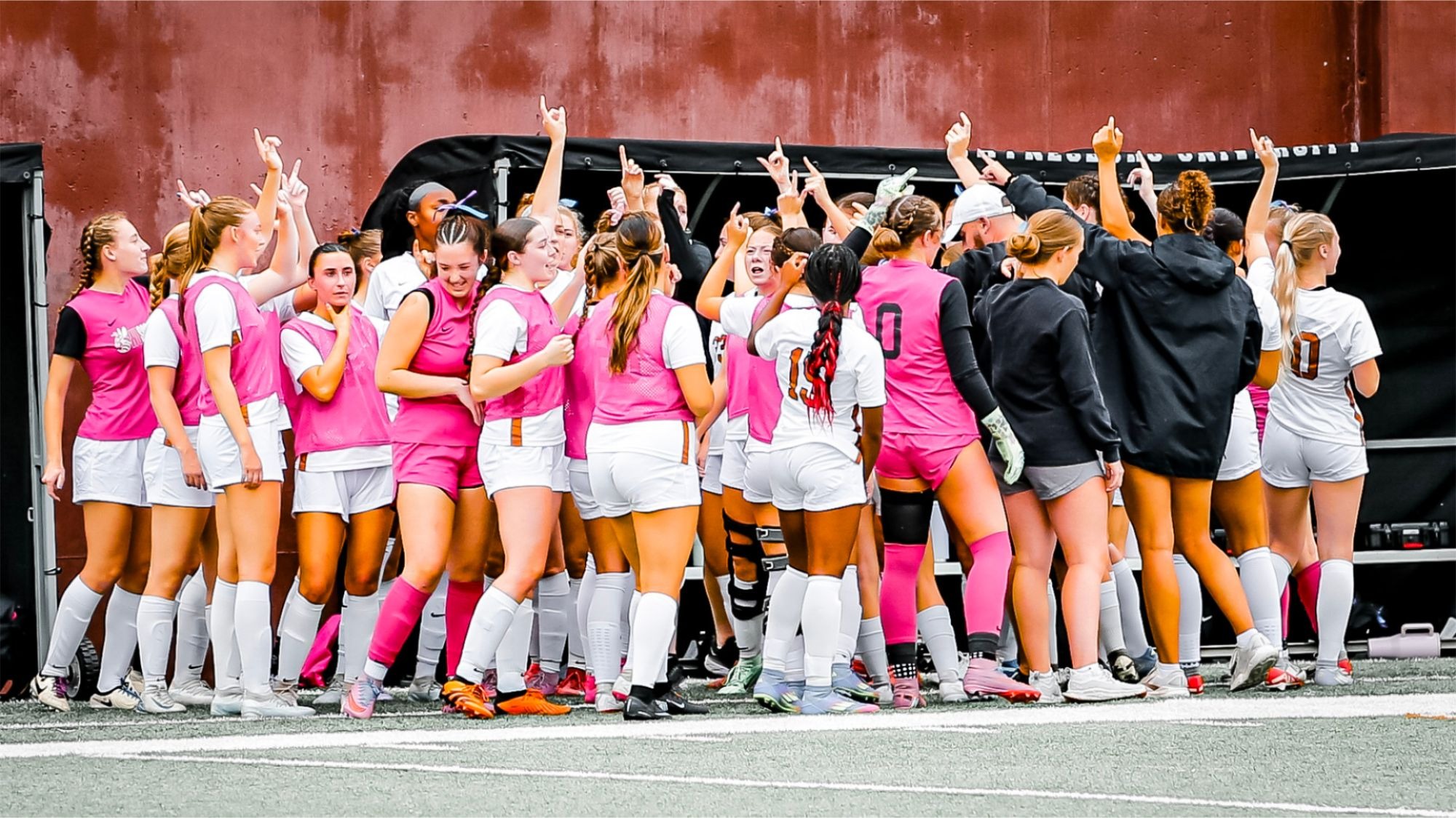 The 2025 women's soccer team ends a pregame huddle with a break 