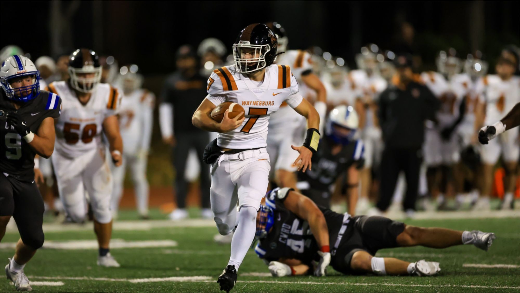 Quarterback Dominic Hickman takes off on a long run with defenders in the background