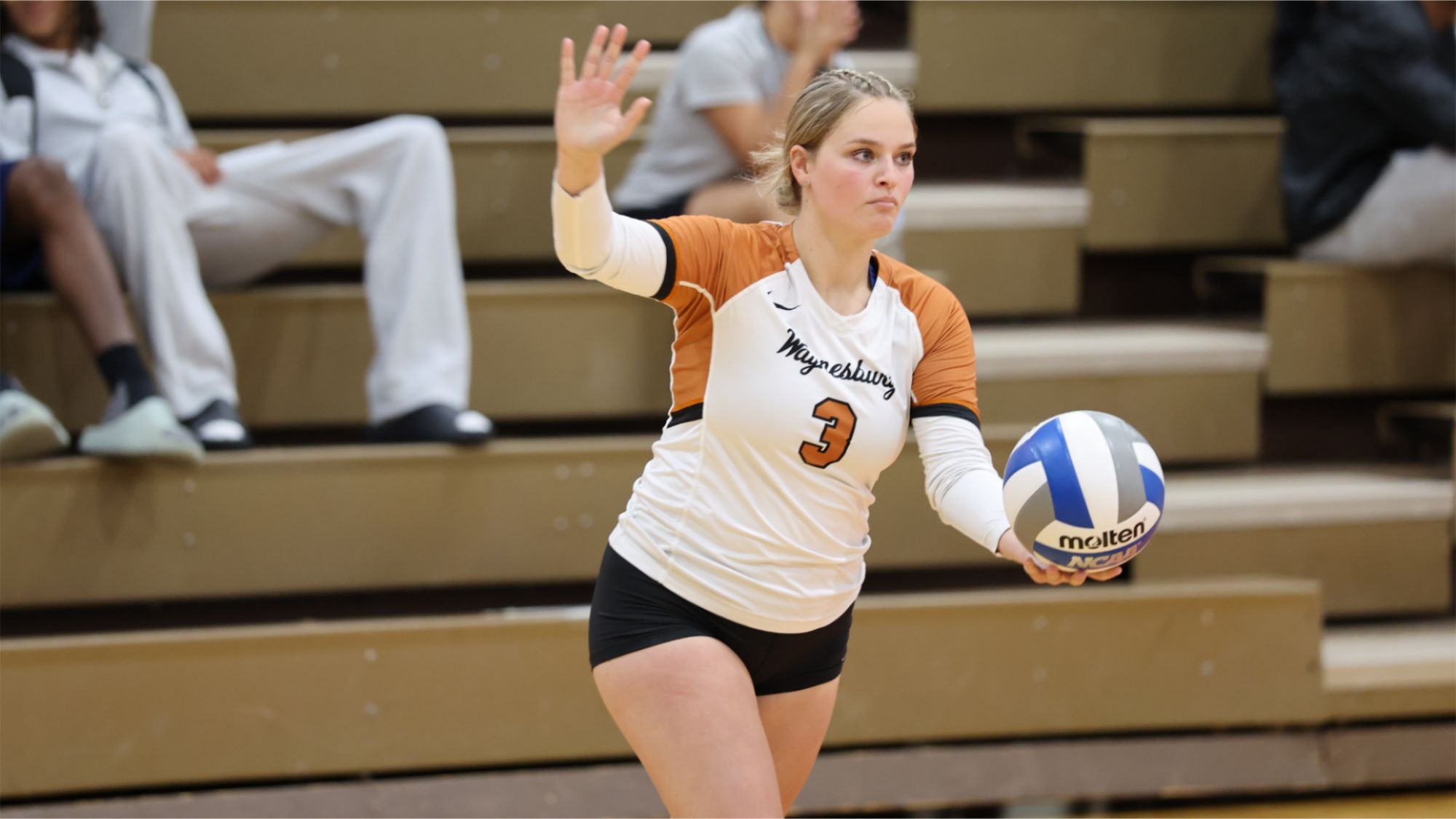Waynesburg's Peyton Kuhns prepares to serve the volleyball
