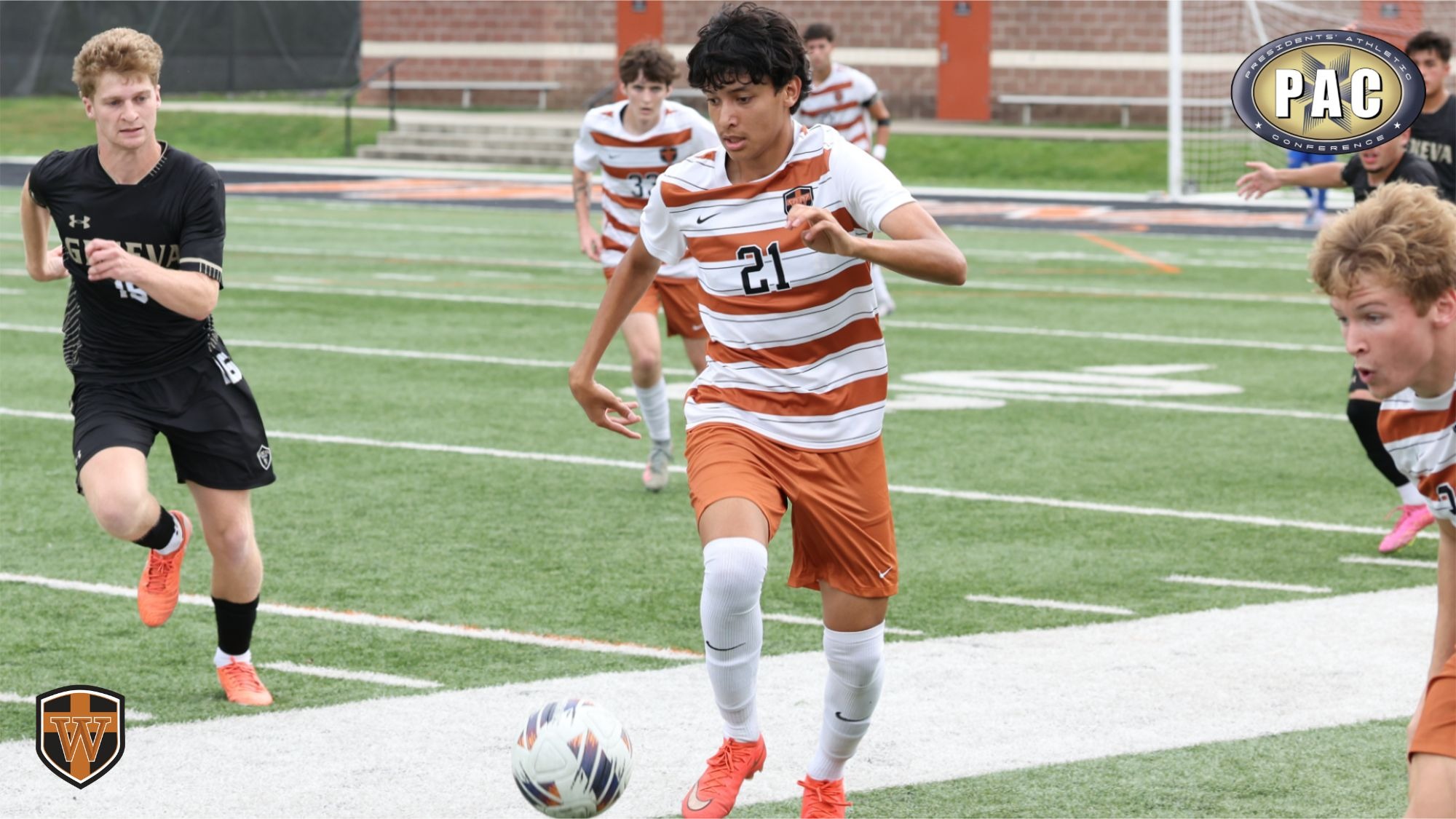 Men's soccer player Johnny Mancias dribbles the soccer ball away from opposing defenders