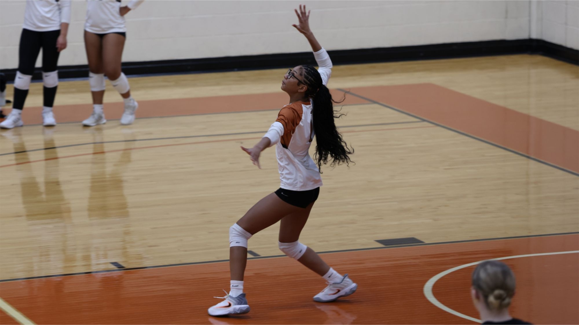 Waynesburg's Kennedy King prepares to serve after tossing the ball up in the air
