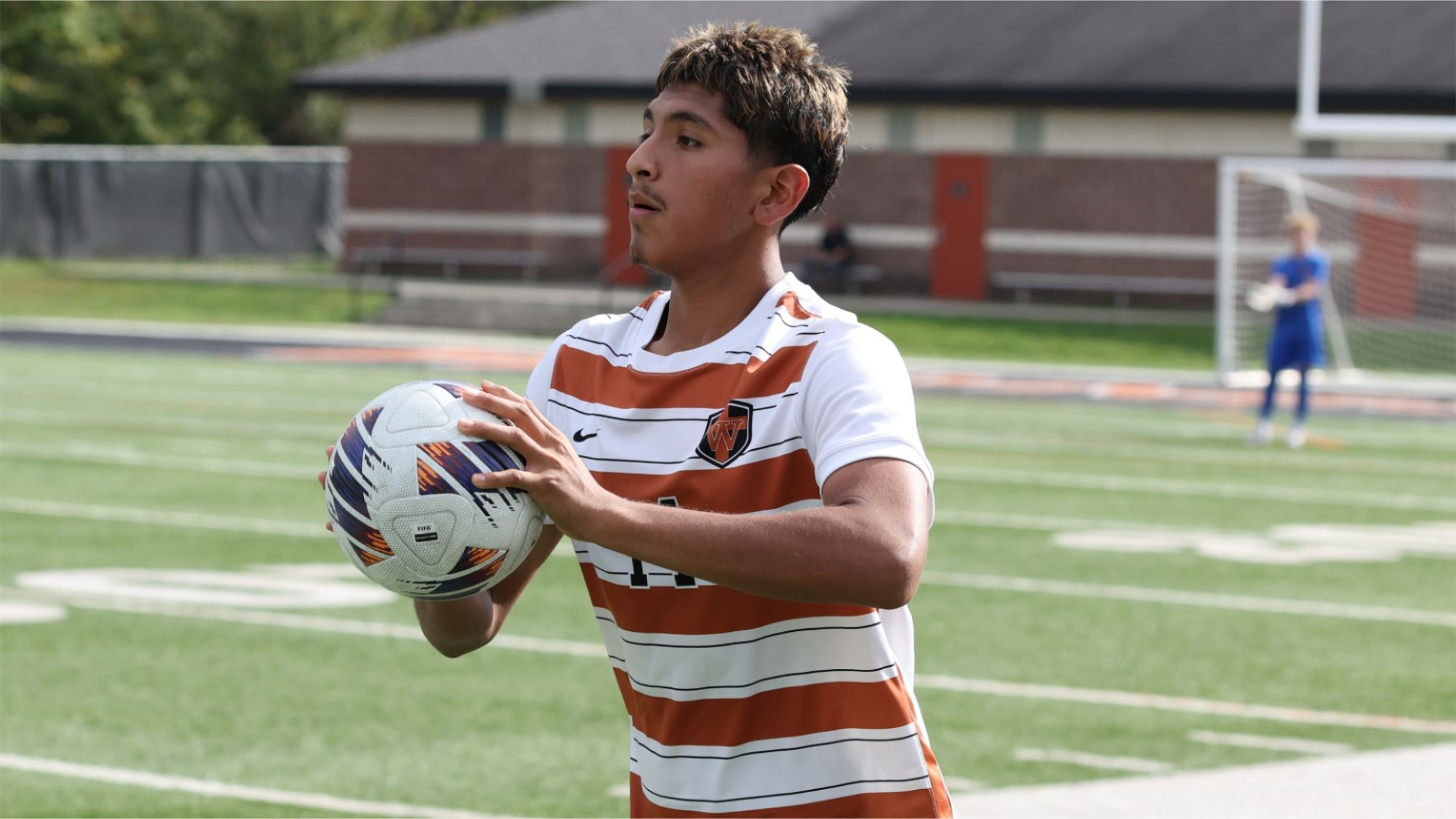 Waynesburg's Matthew Serrano gets ready to throw the soccer ball in from the sideline