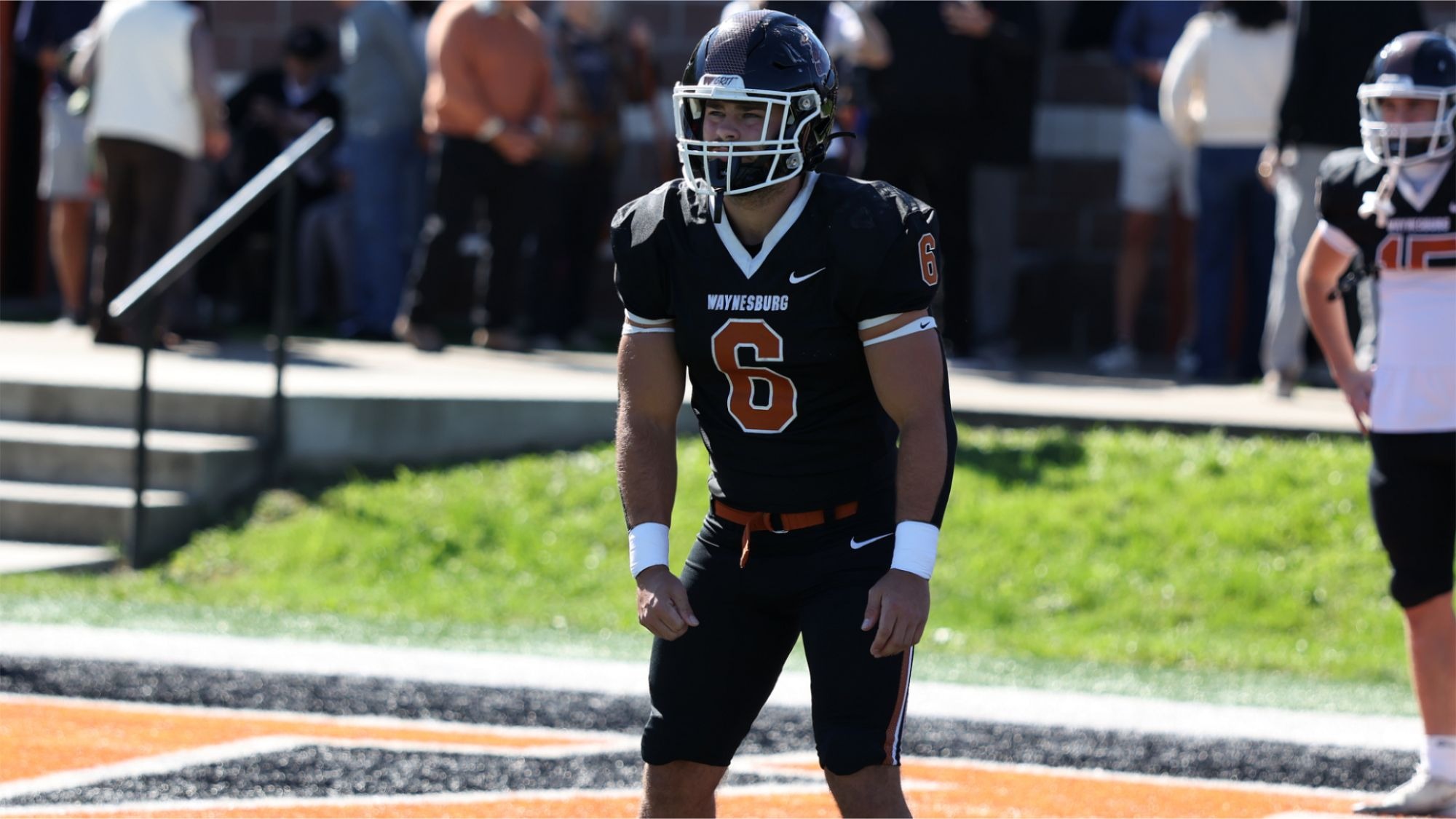 Waynesburg's Carson Shriver, wearing his black home uniform and black helmet warms up before a game