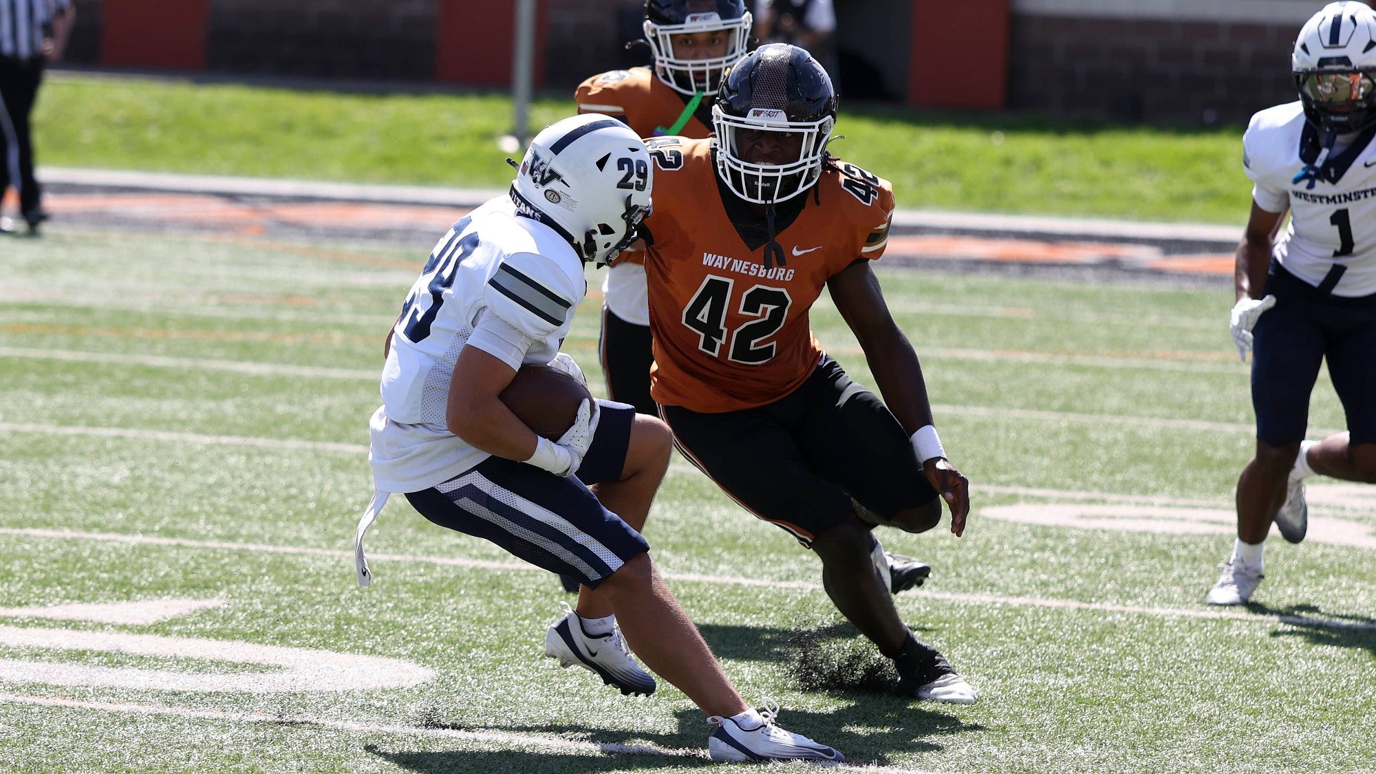 Waynesburg's Joanes Polynice eyes up a Westminster player for a tackle