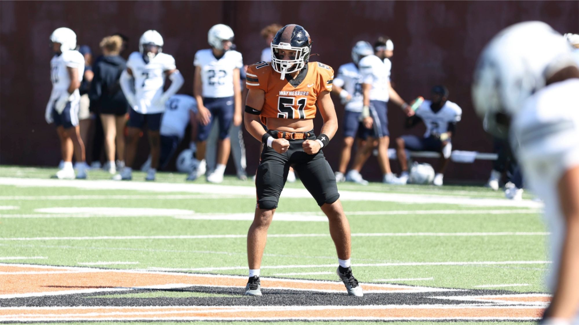 Jacob Morgan wearing number 51 looks to the sideline for the play call