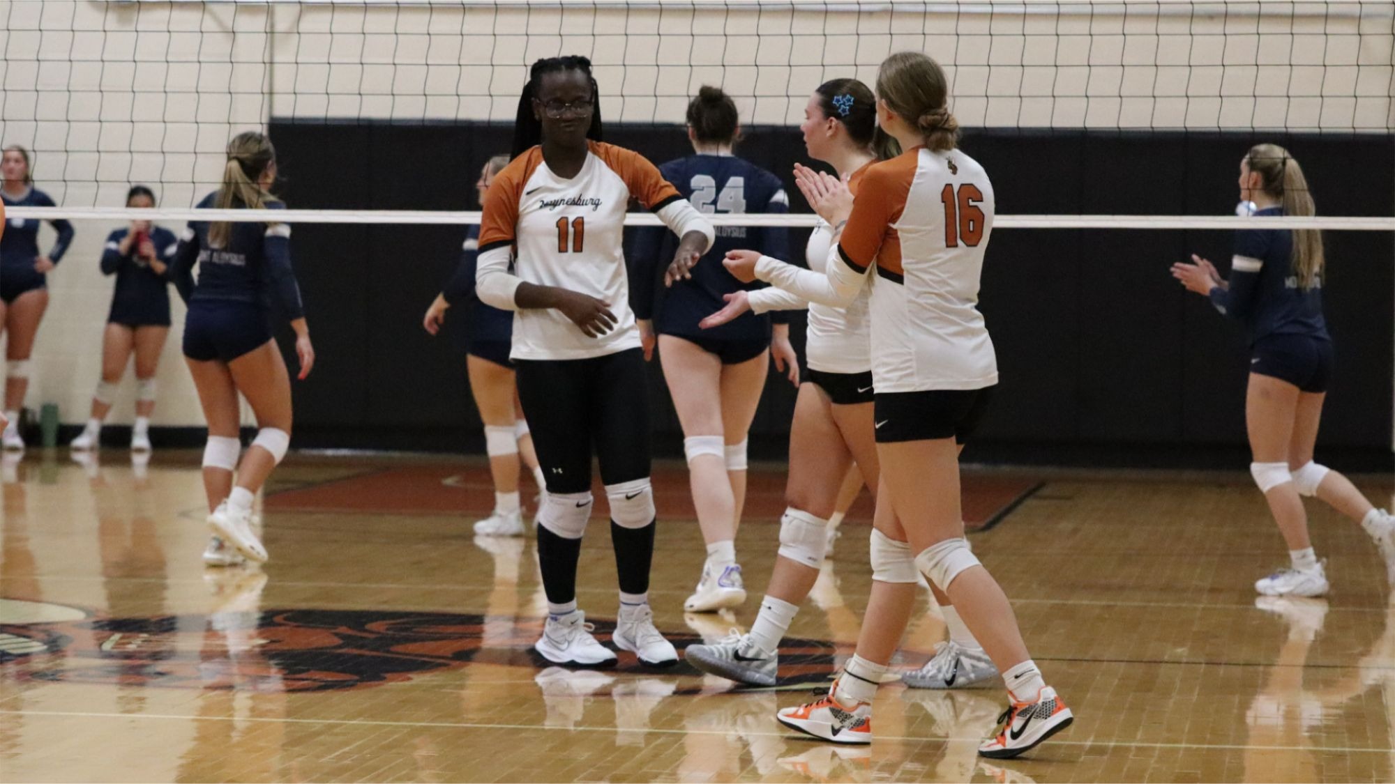 Four Yellow Jackets gather after a point around the net