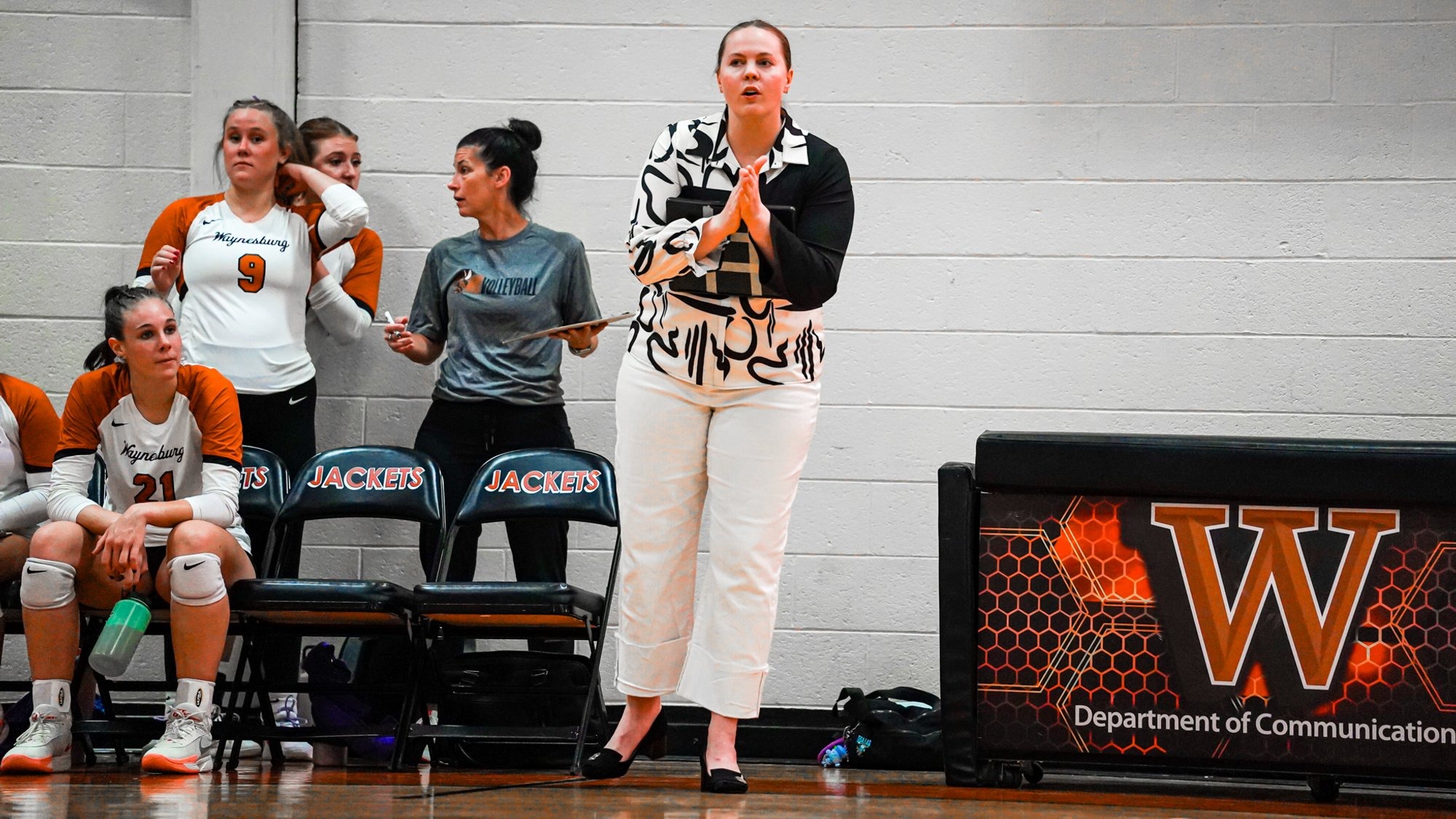 Coach Hope Johnston standing on the sideline