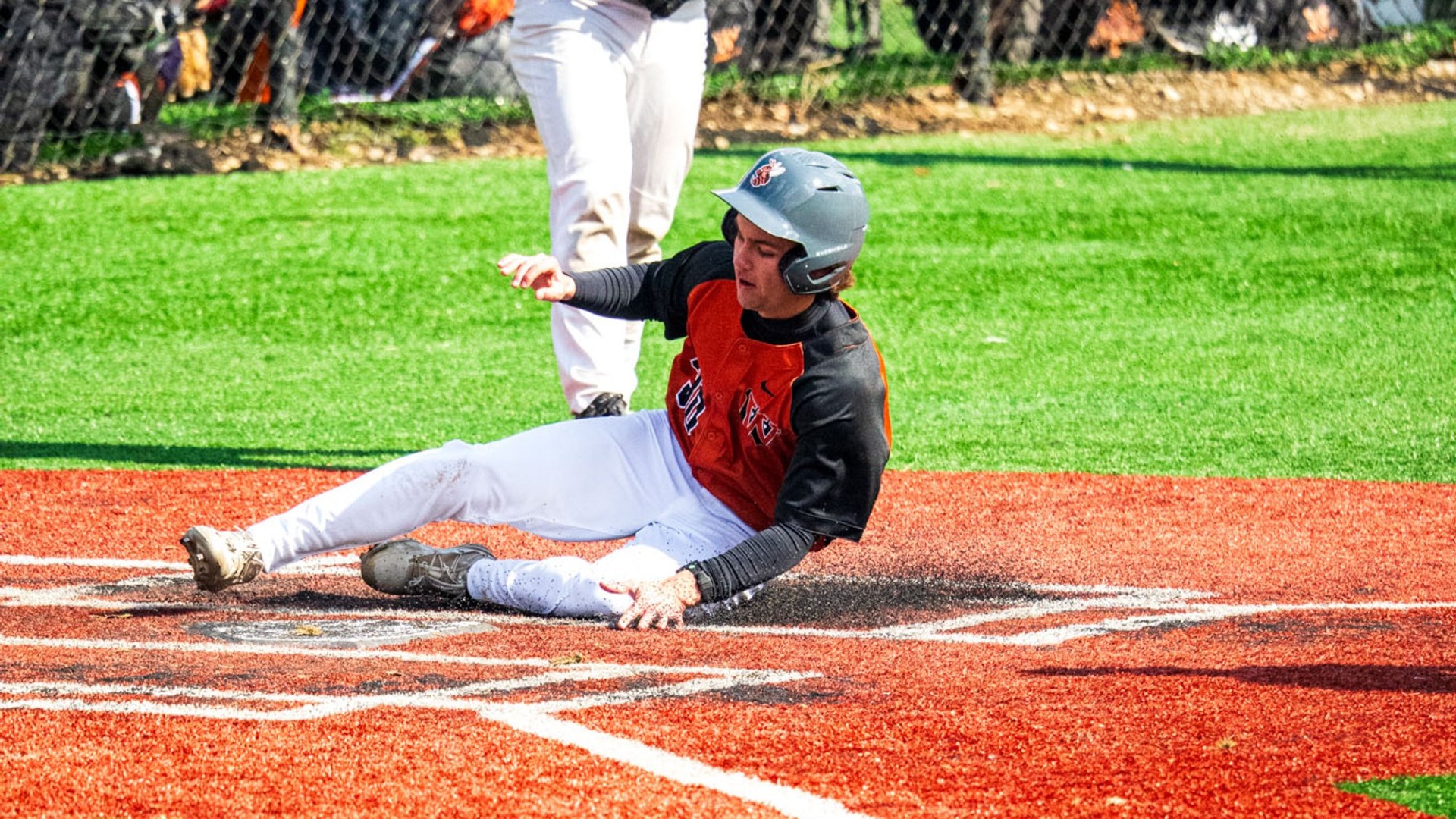Jacket baseball player slides into home