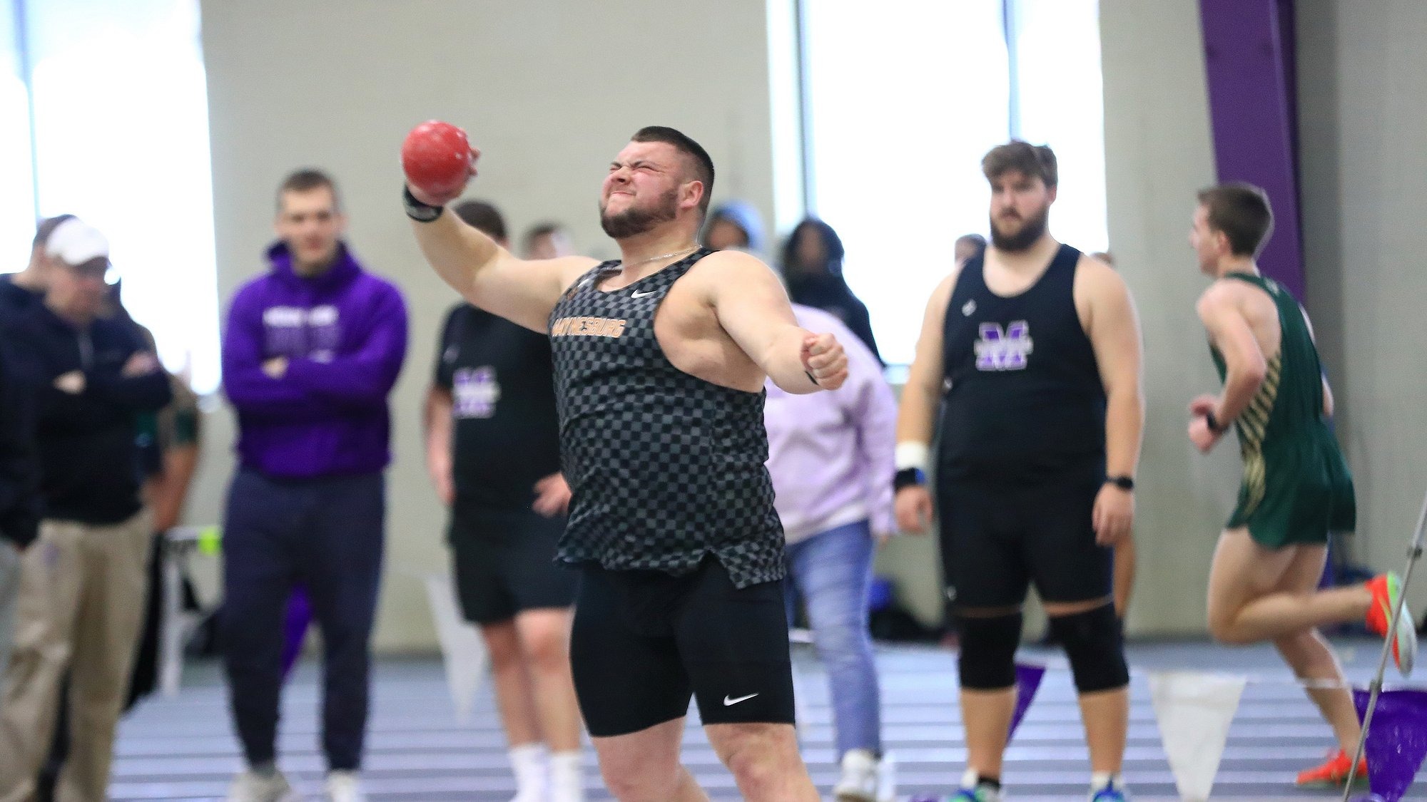 Jacob Harker throwing the shot put