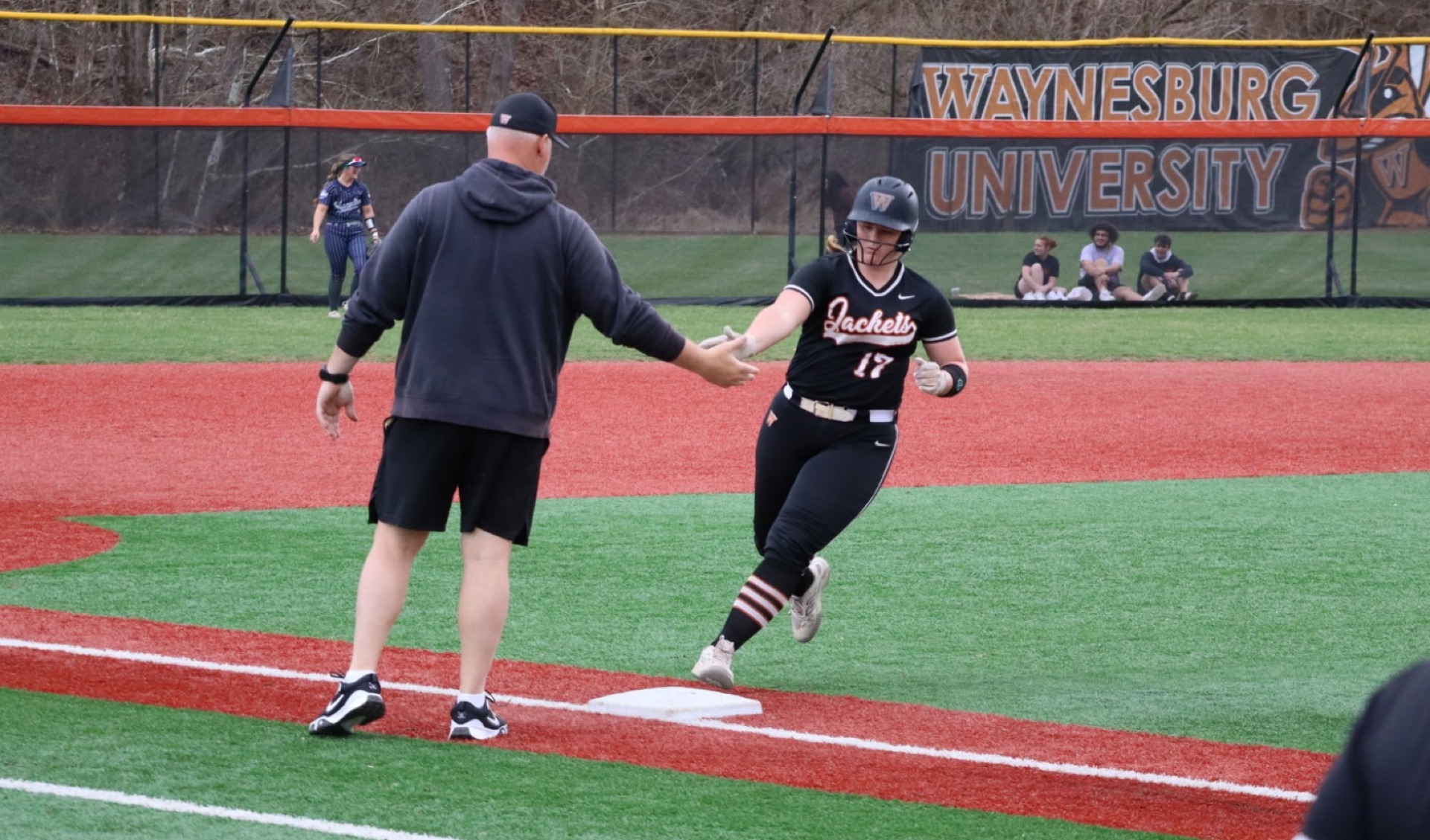 Corbin gets a five from head coach Chris Brunson after a homerun