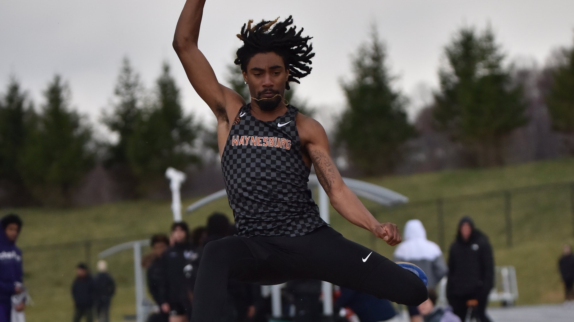 Noah Jones competing in the long jump
