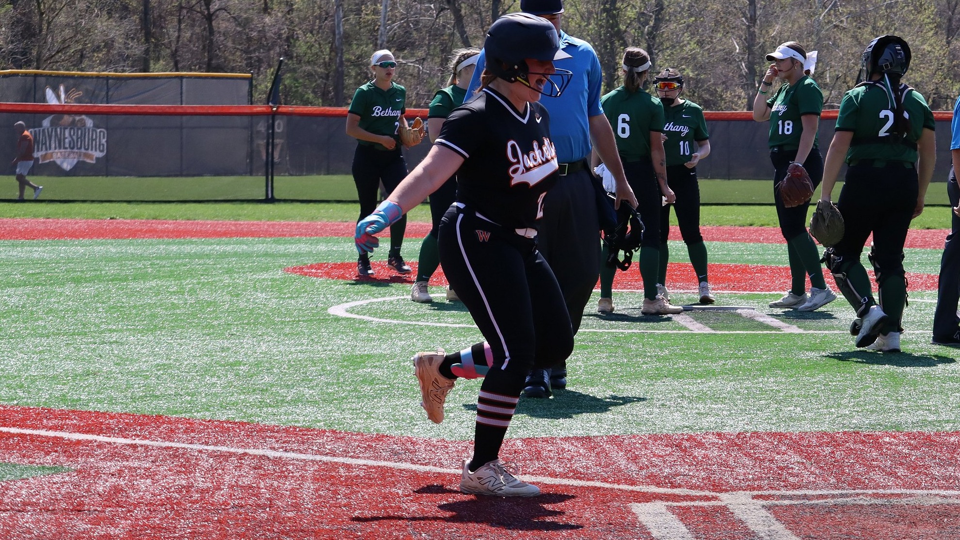 Rylee Rohbeck crosses home plate with a smile after a homerun