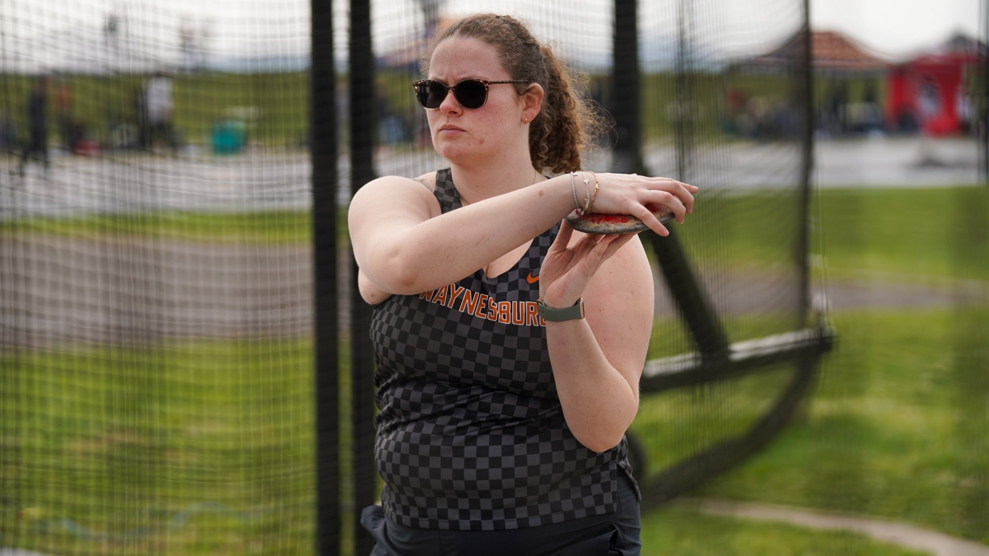 Waynesburg women's discus thrower warming up in sunglasses