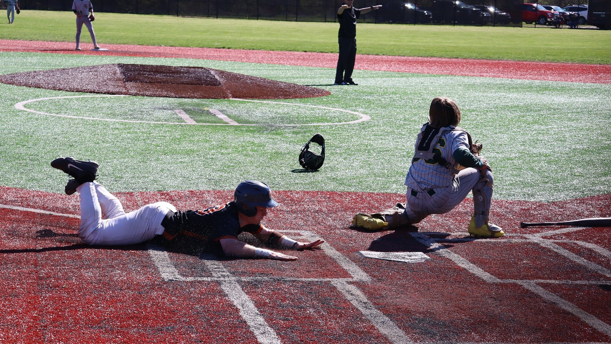 Waynesburg runner slides into home plate to score a run