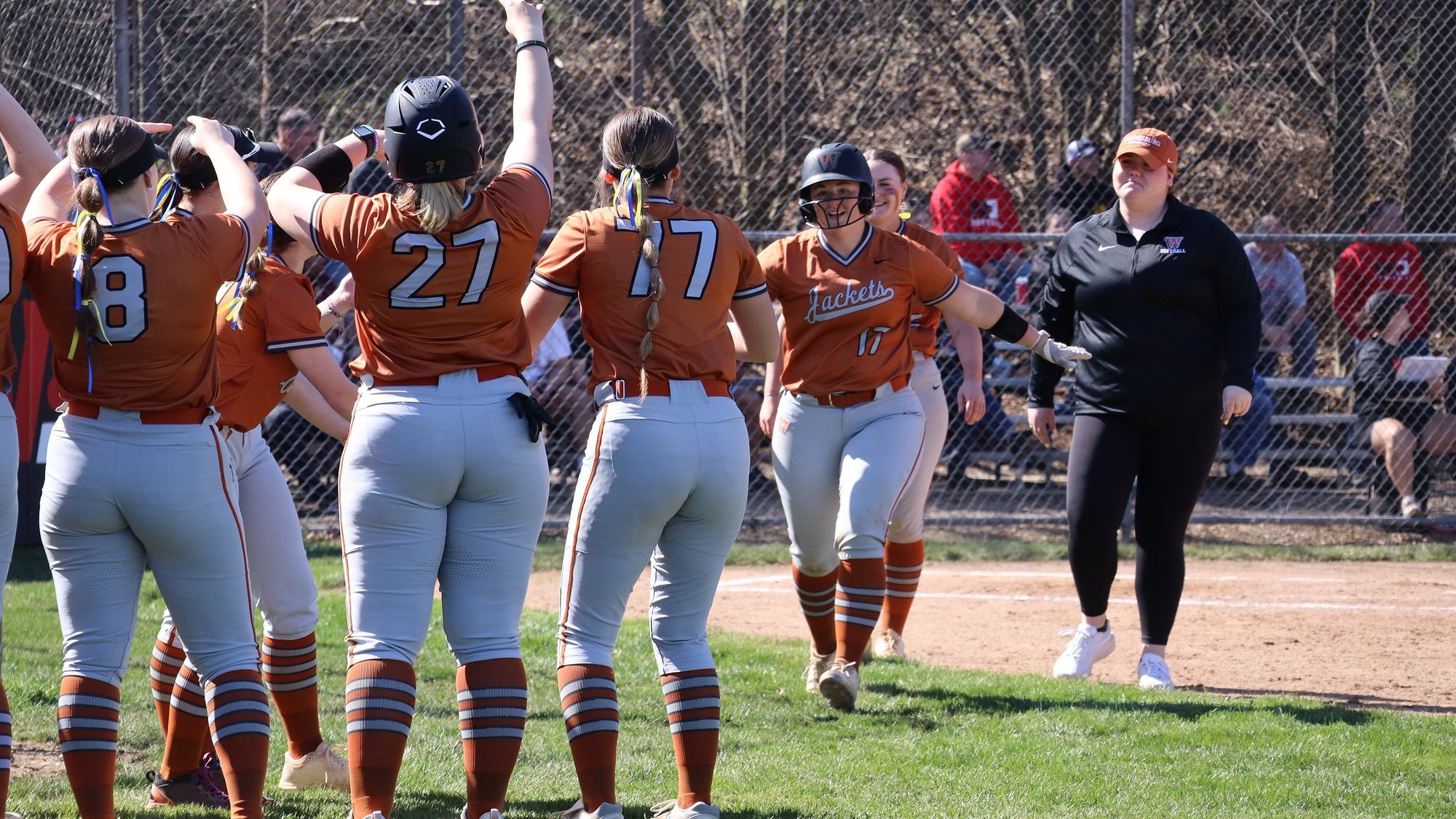 Corbin celebrates with her teammates at home plate
