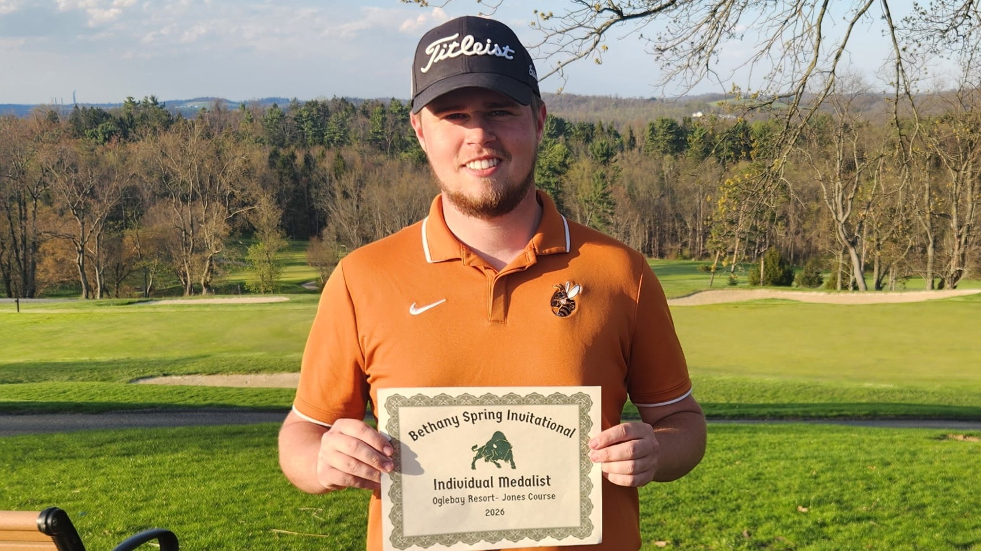 Matt Karpeal shows off individual medalist certificate