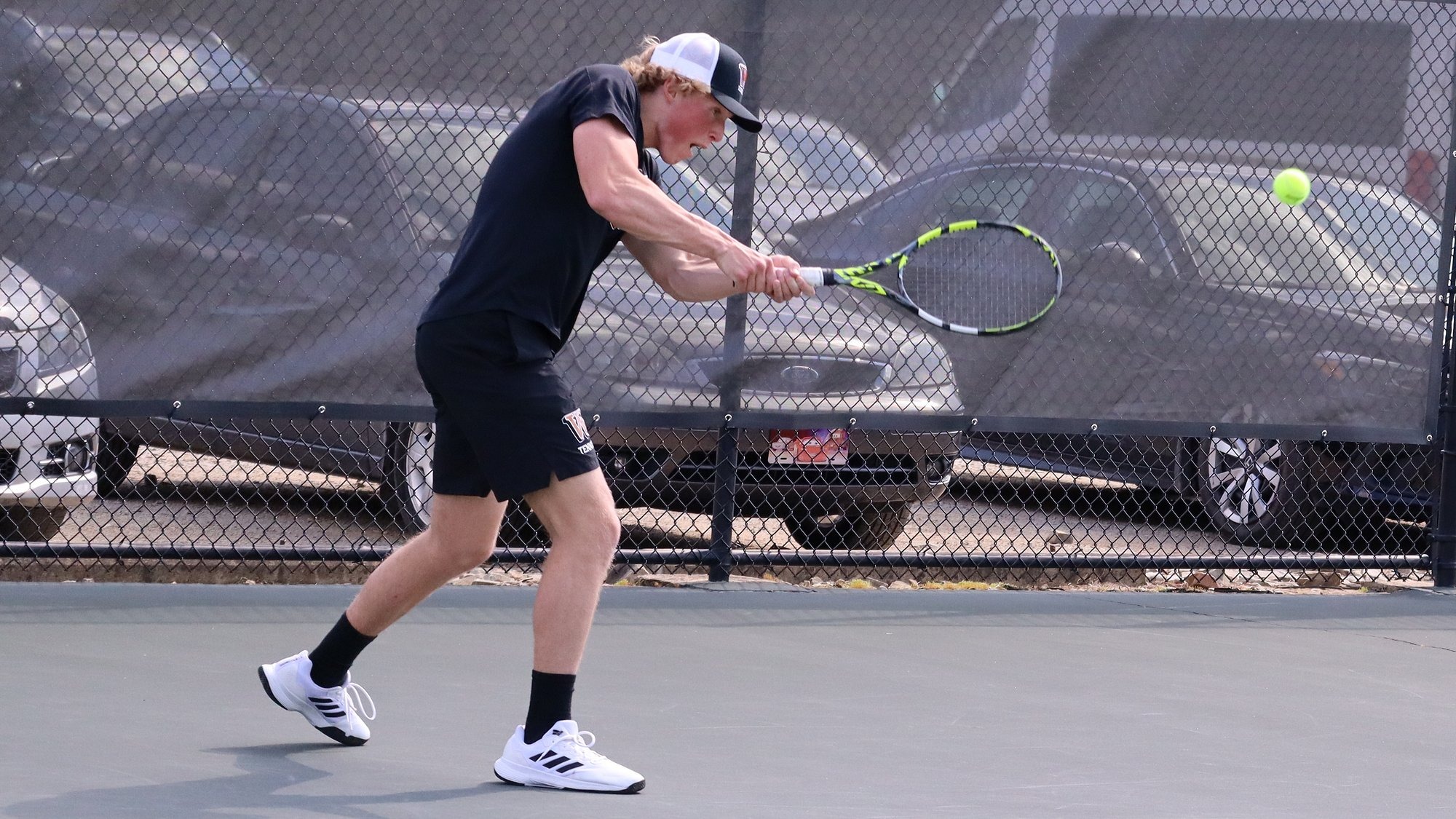 Pictures of Ethan Clawson hitting a backhand