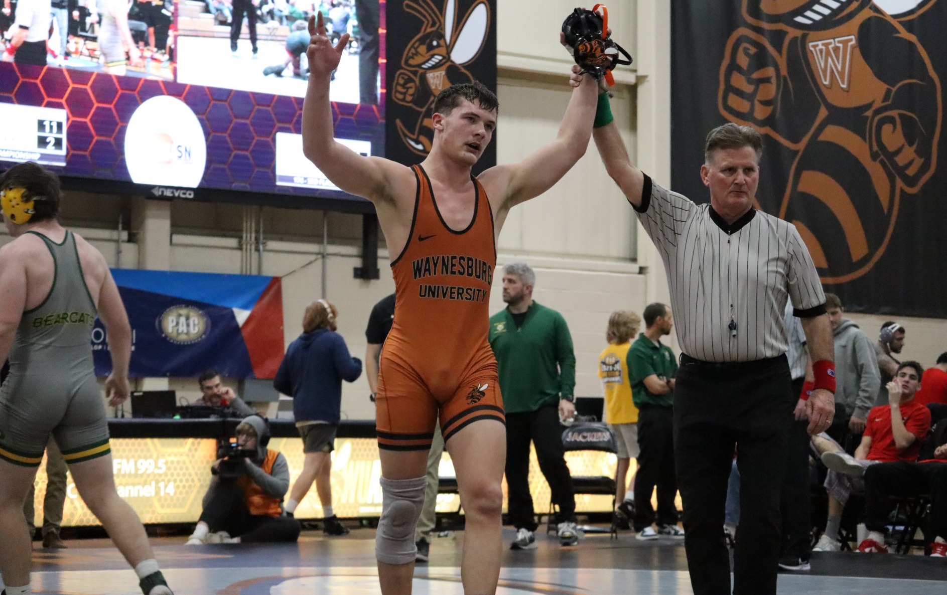 Jessie Orbin having his hand raised after winning his match against an opponent from Saint Vincent