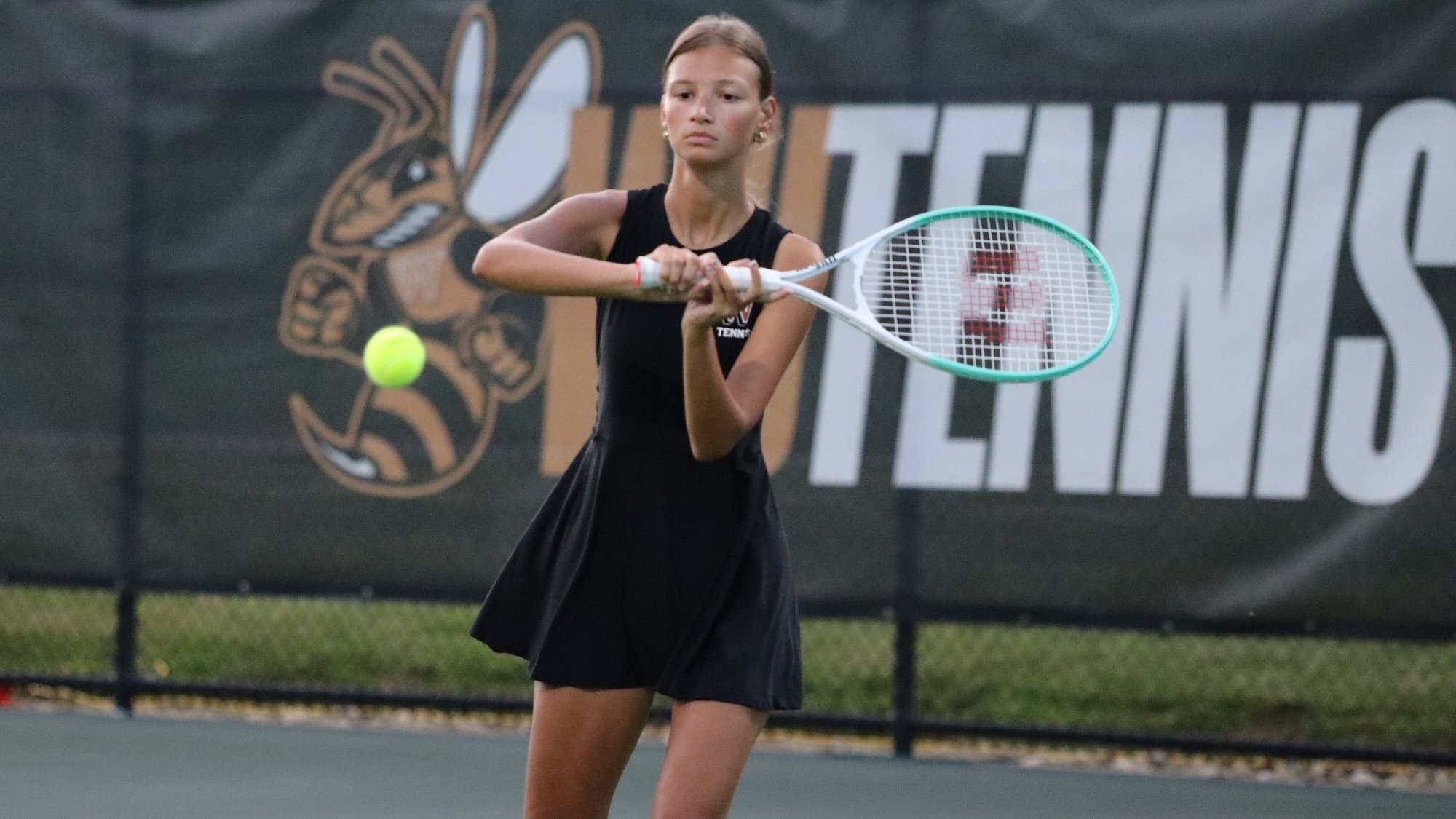 Mackenzie Gower hits a shot on the tennis cour