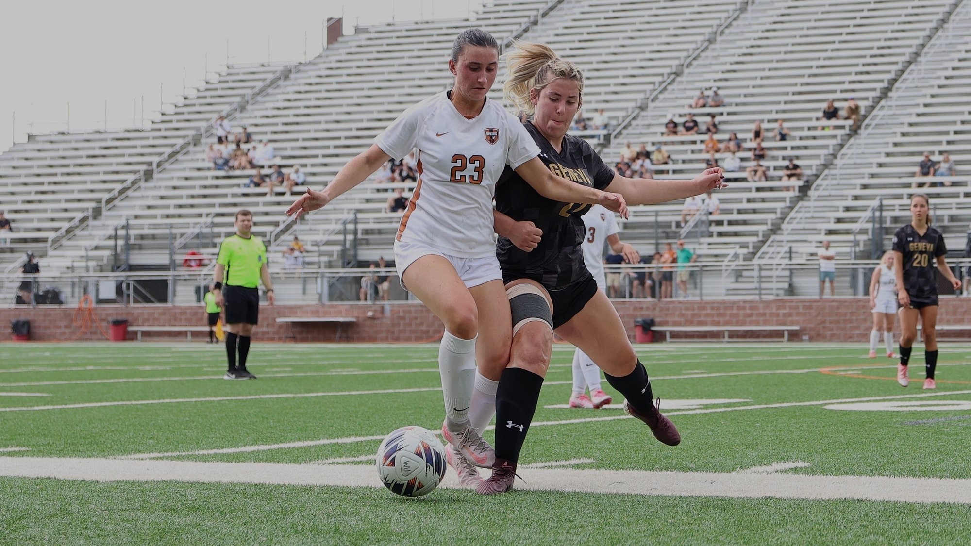 Waynesburg's Abby Woodford battles a defender along the sideline with John. 