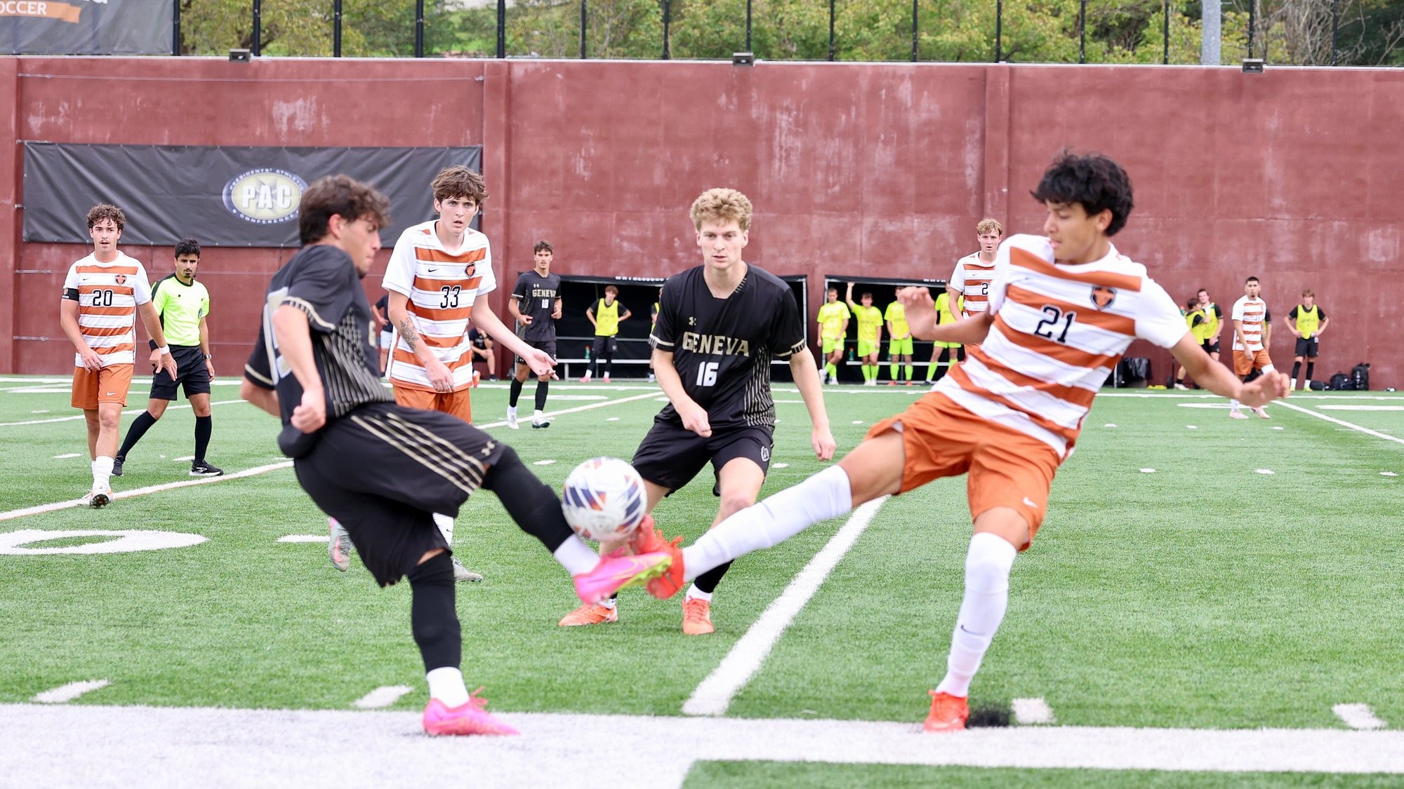Waynesburg's Johny Mancias battles an opponent from Geneva for the ball while other players look on in the background