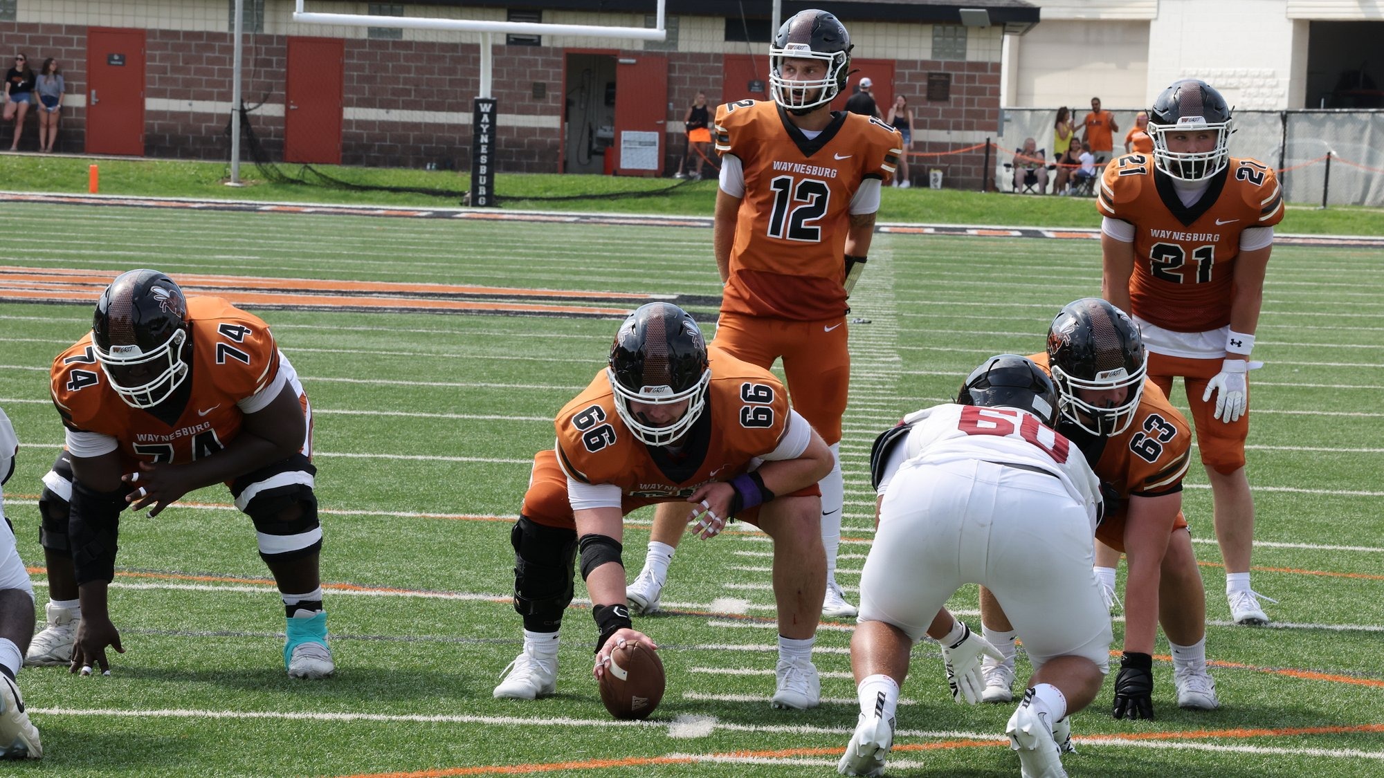 Quarterback Luke Hudson looks over the defense as he stands in the shotgun behind his offensive line