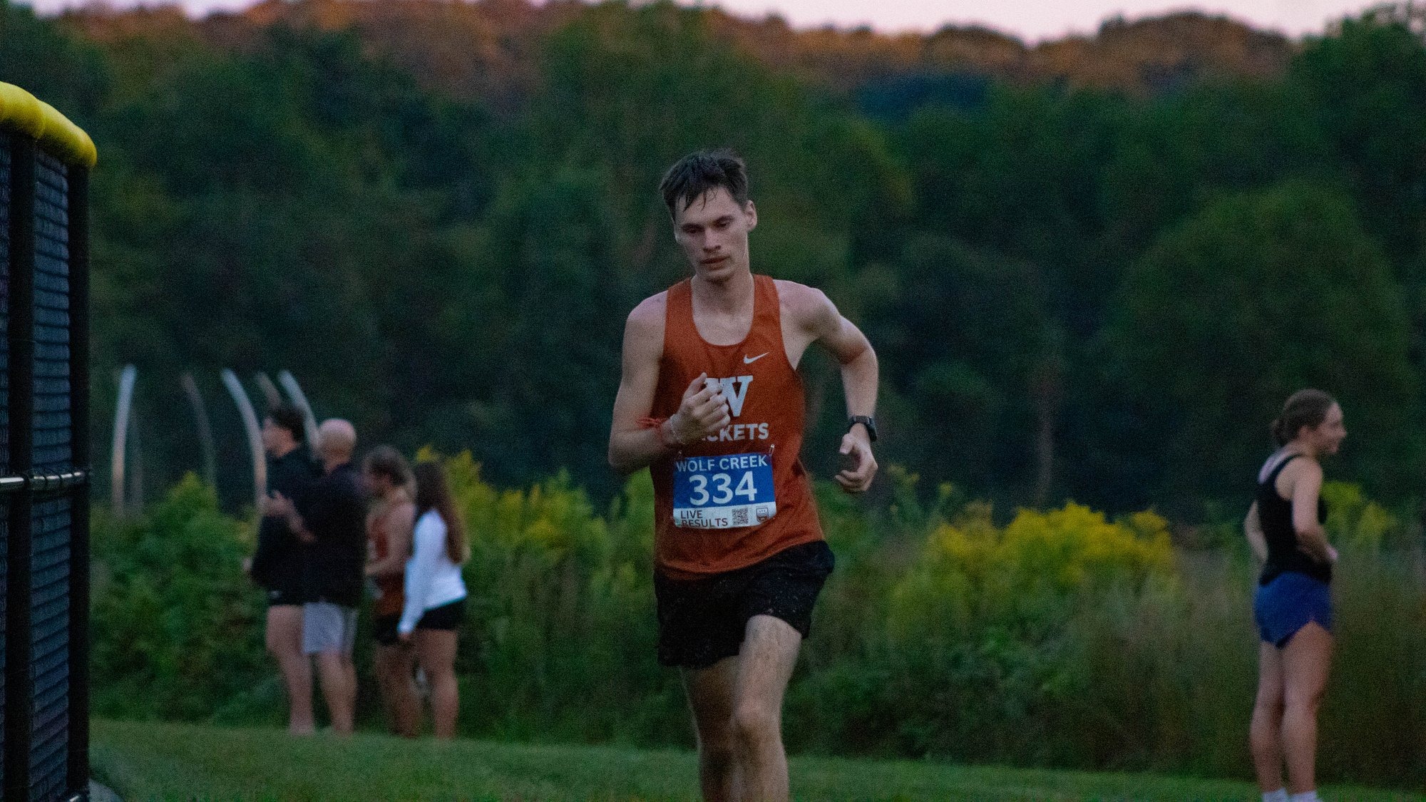A Waynesburg cross country runs on a grassy course