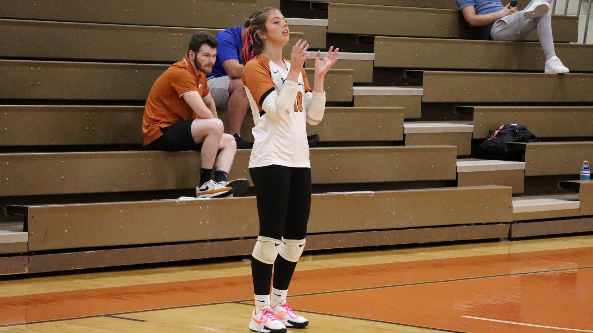 Waynesburg's Katie Cottis stands behind the service line and waits for the ball to be tossed to her in preparation of a serve