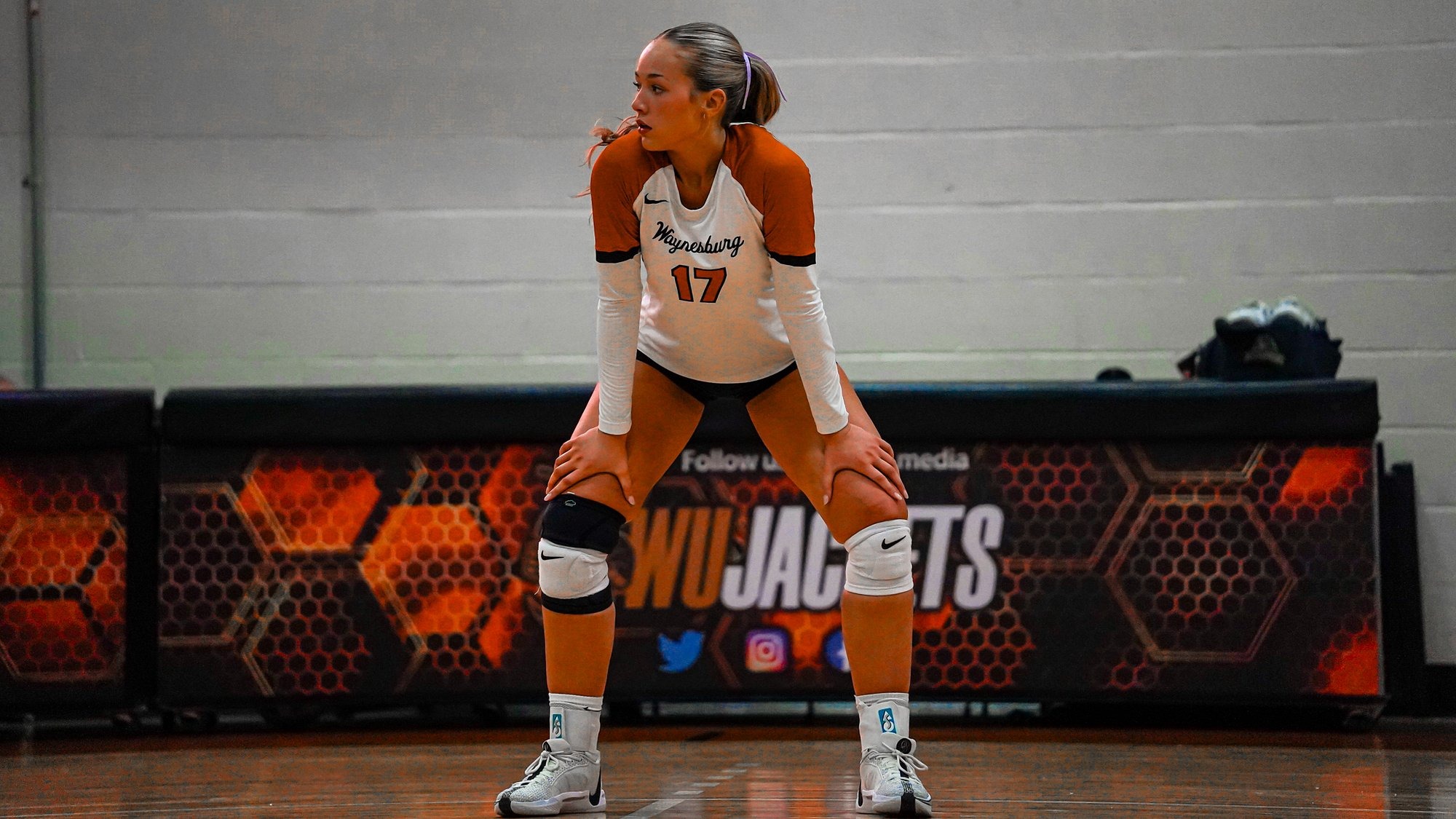 Audrey Work stands on the court with her hands on her knees
