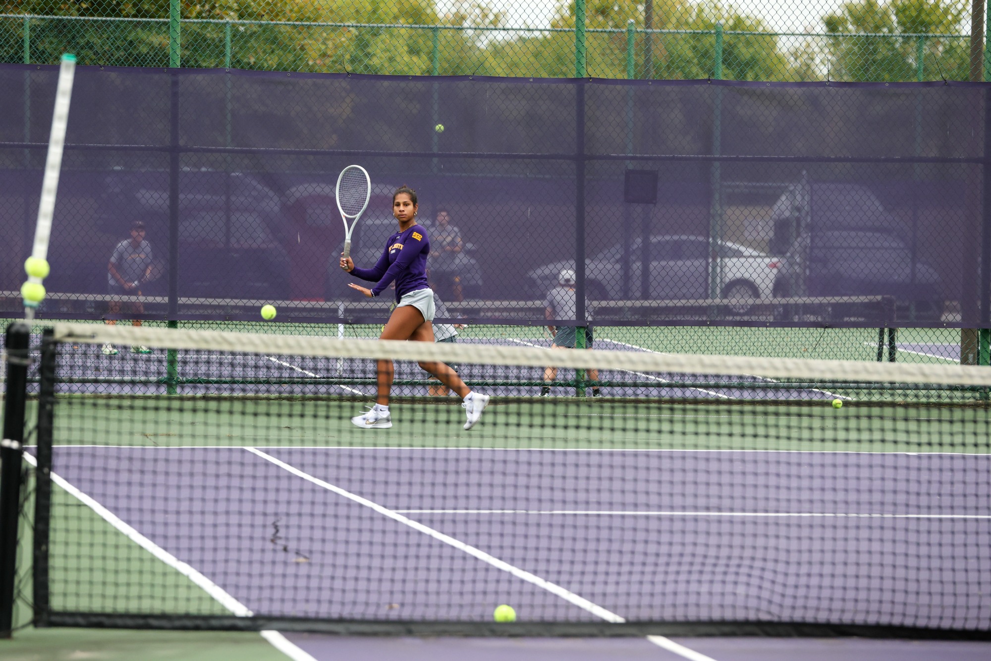 Player winds up to hit ball at tennis practice