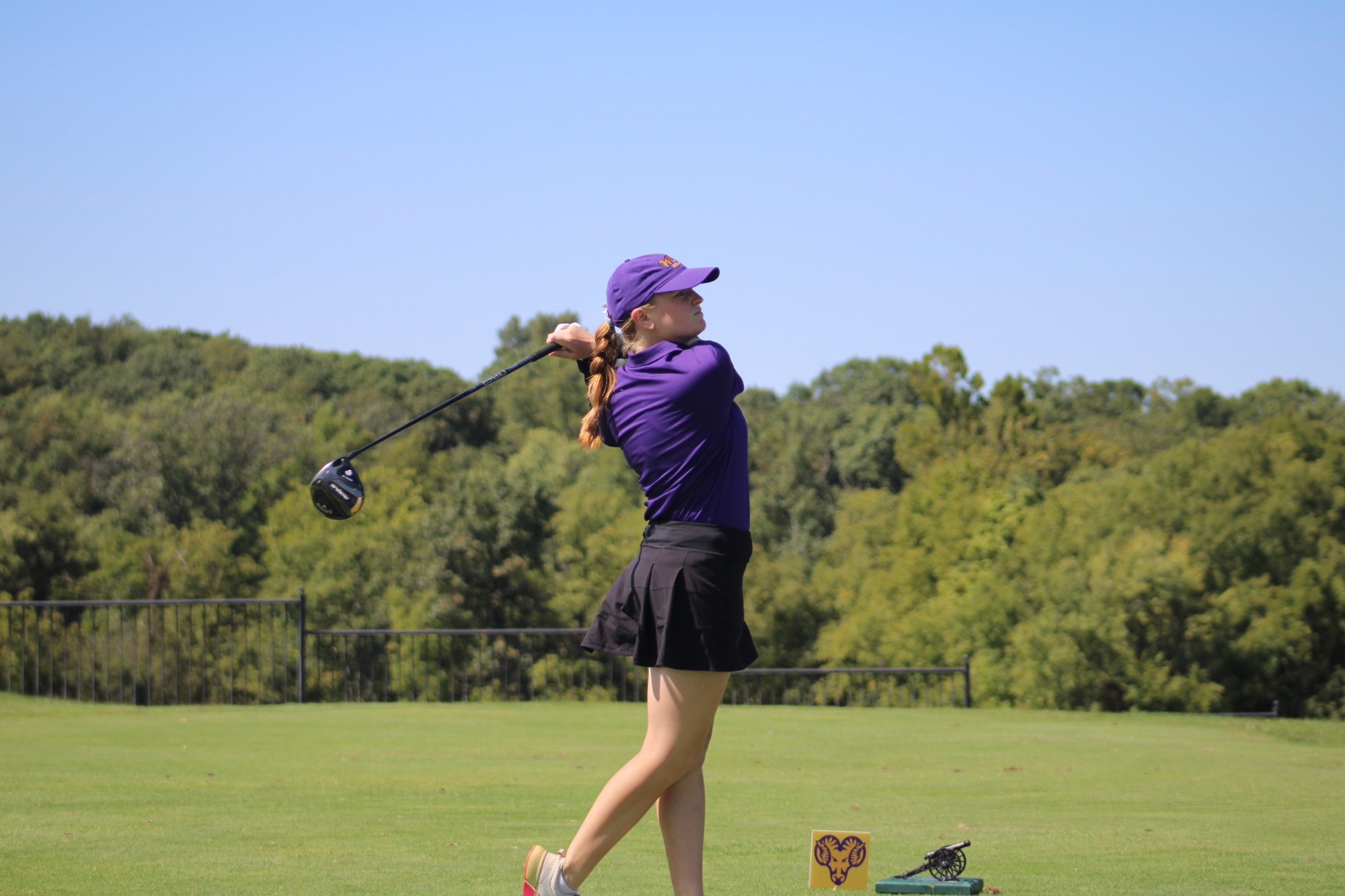 Barkley IN BACKSWING WEARING TEAM ISSUED PURPLE HAT, PURPLE SHIRT, AND BLACK SKIRT