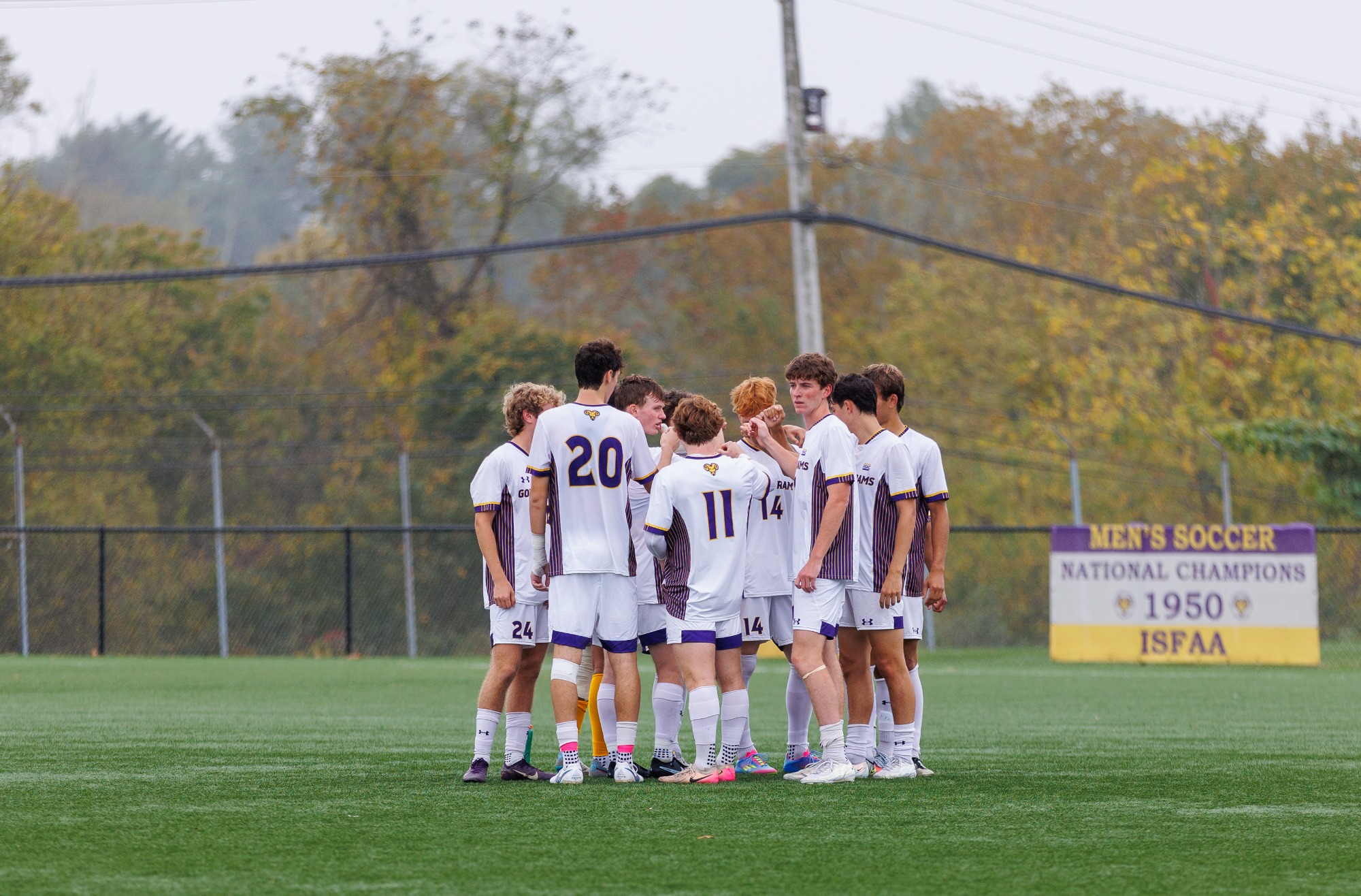 Men's Soccer starters huddle up on the field at Rockwell prior to a game 