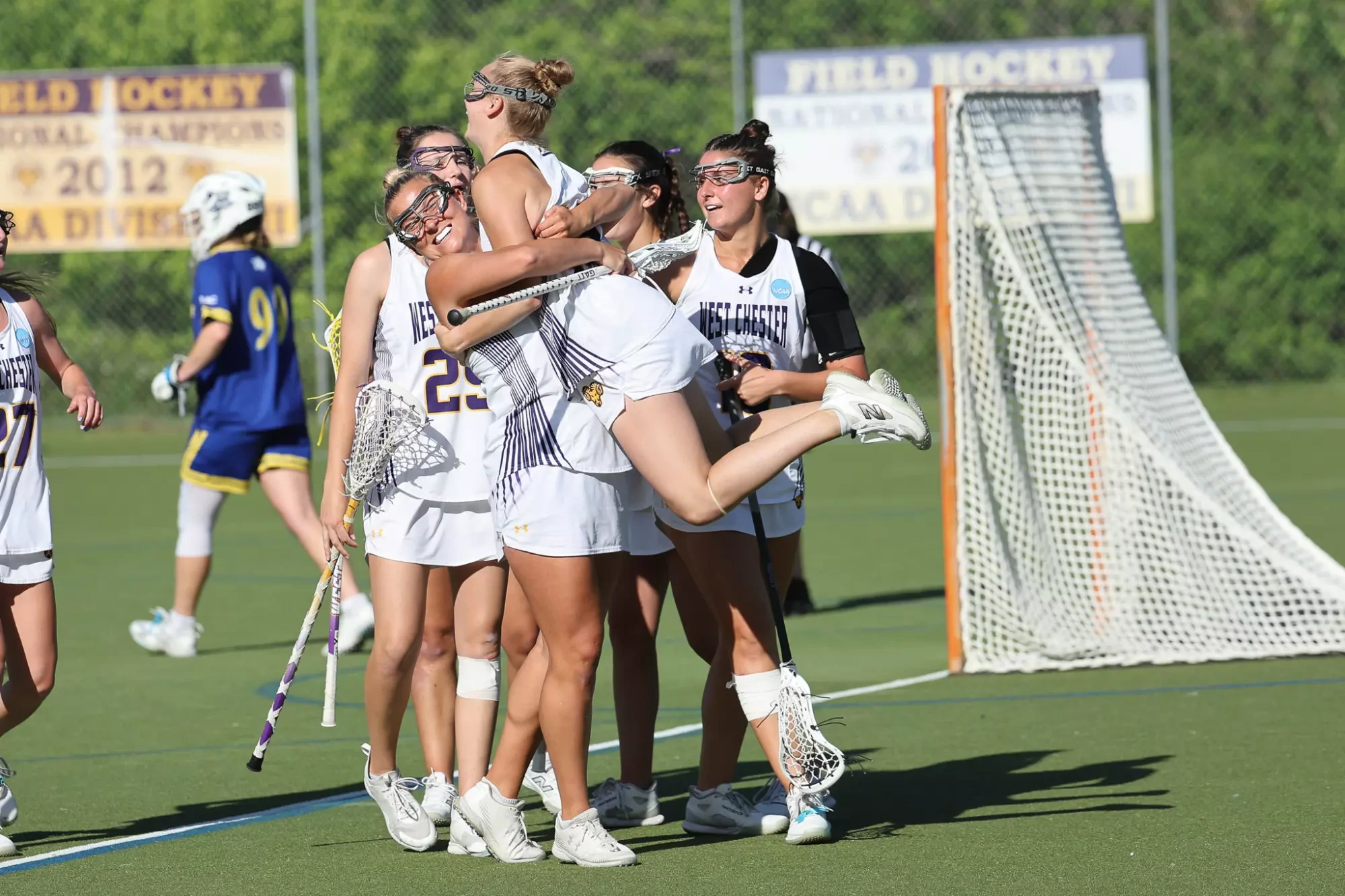 Kendall Fortune celebrates a goal by jumping into the arms of teammate Sydney Wasdick as Madeline Edinger as Nicolette Giordano joins in the celebration.