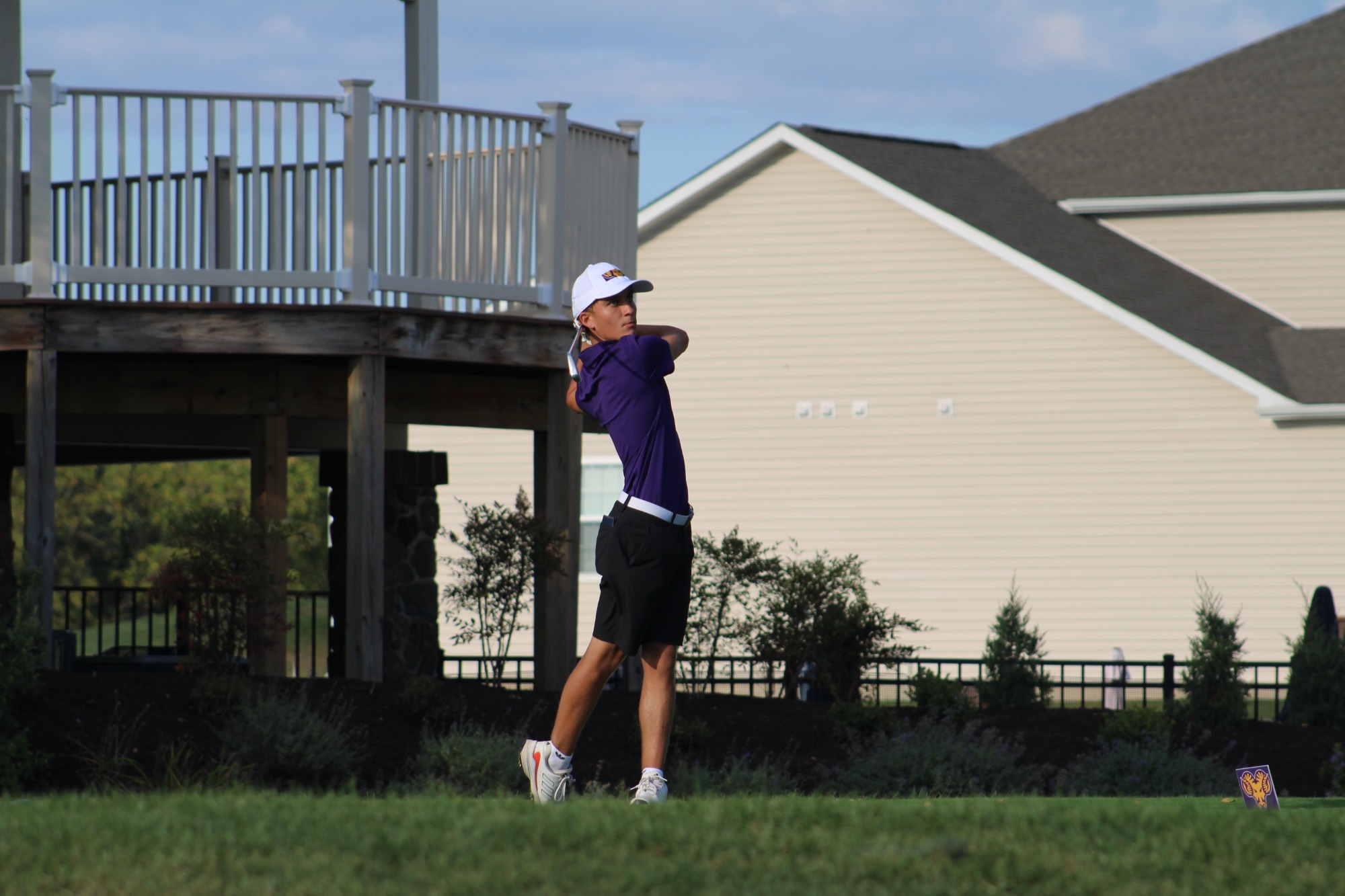 ROTH IN BACKSWING WEARING TEAM ISSUED WHITE HAT AND PURPLE SHIRT 