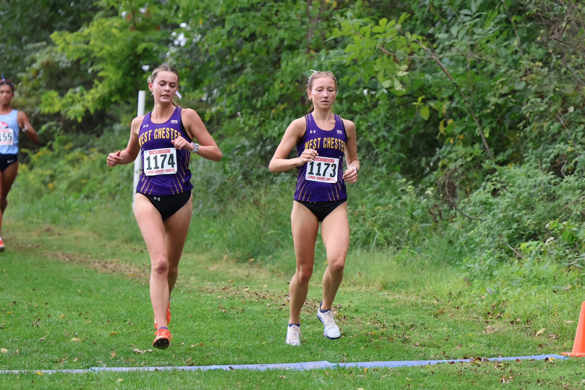 PAIR OF WOMEN'S CROSS COUNTRY RUNNERS COMING ACROSS FINISH LINE DICKINSON LONG-SHORT INVITATIONAL