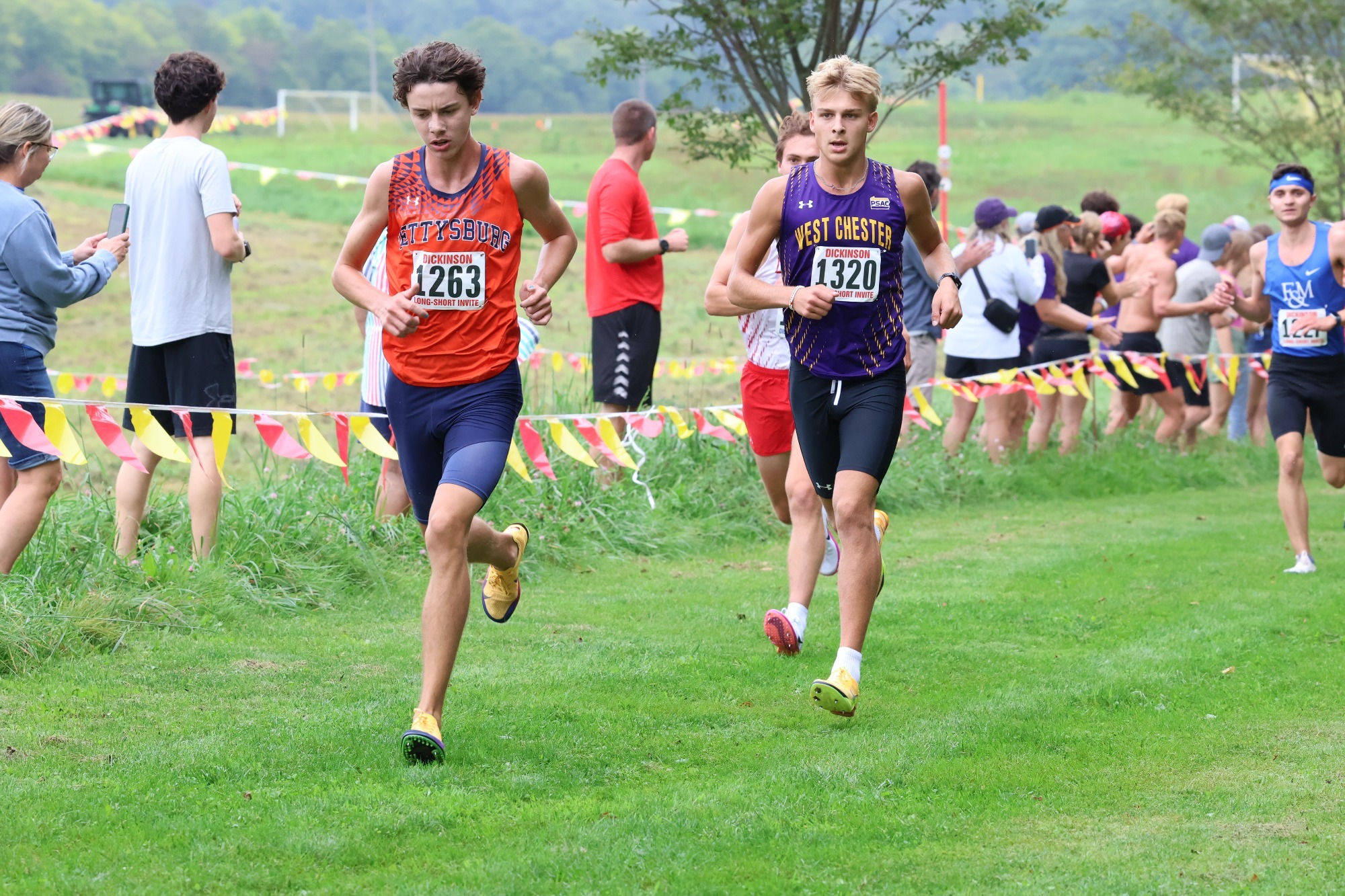 Wyatt Nelson wearing bib 1320 on purple racing top running down hill at Dickinson Long-Short