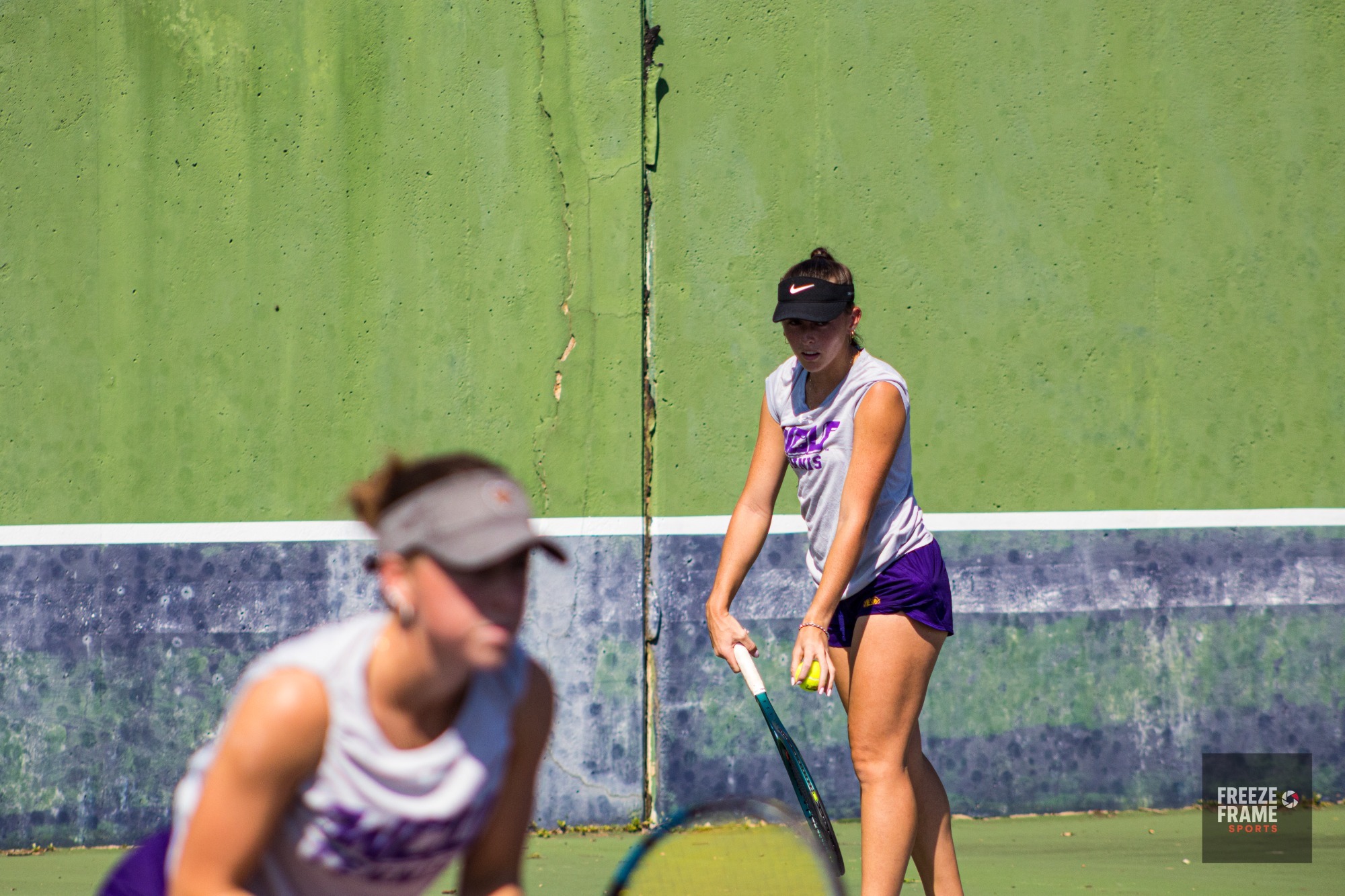 DELANEY TINGLE PREPARING TO SERVE IN DOUBLES PLAY ALONGSIDE GRACIE CLARK IN WEST CHESTER DURING FALL SEASON