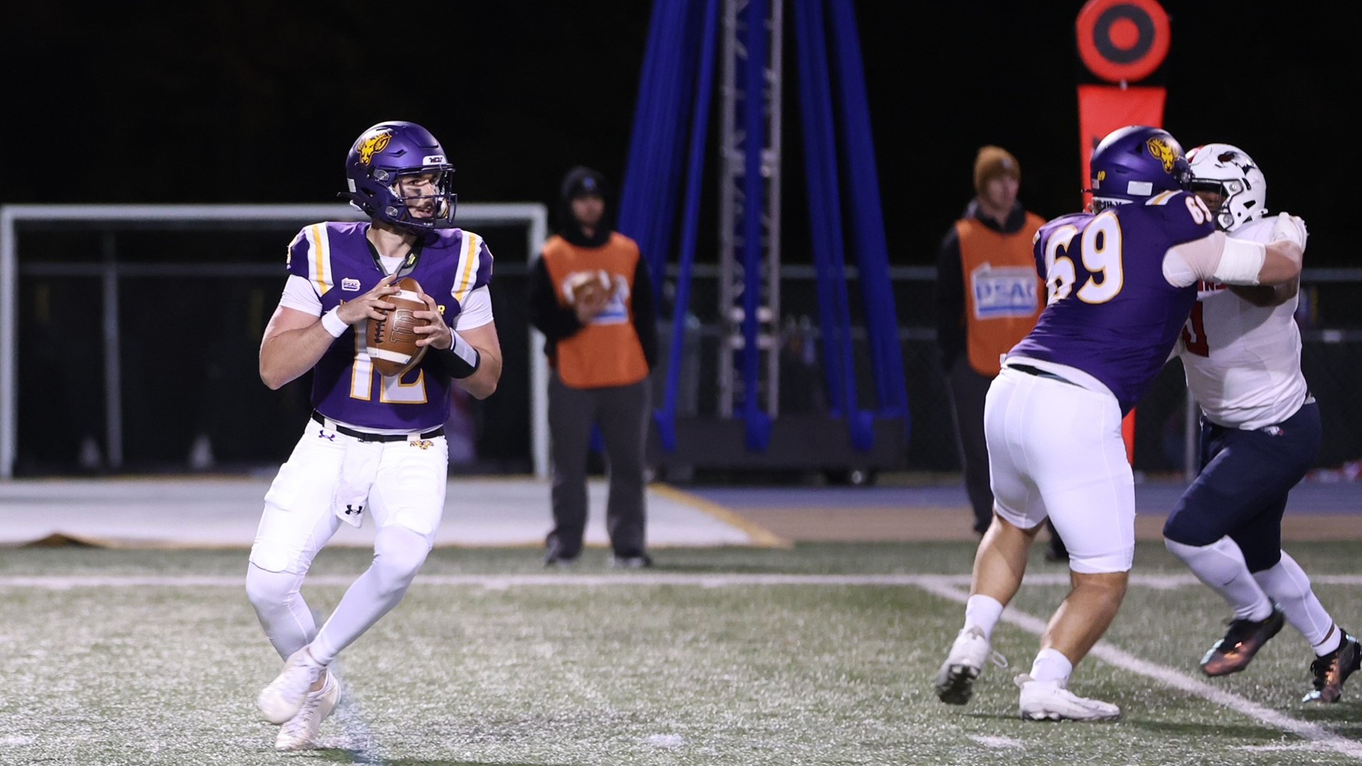 Jack Pellicciotti drops back to pass as Tucker Valoczki blocks against Lackawanna Saturday night at Farrell Stadium.