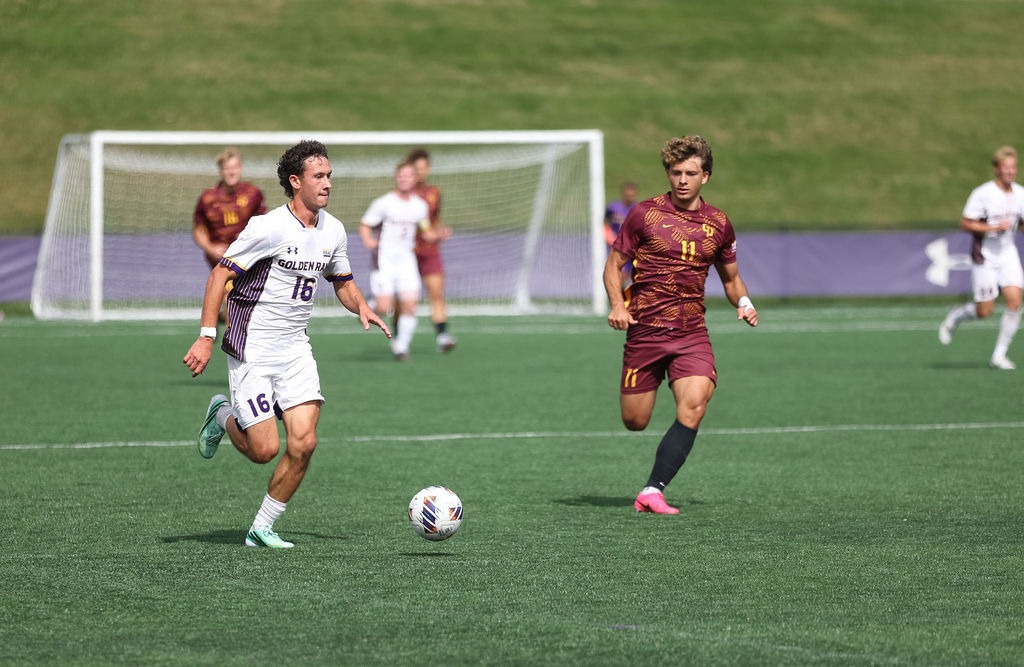 Joseph Maxwell wearing home whites with purple numbers and purple golden rams across chest carries the ball upfield past a Gannon defender wearing all maroon kits with gold numerals
