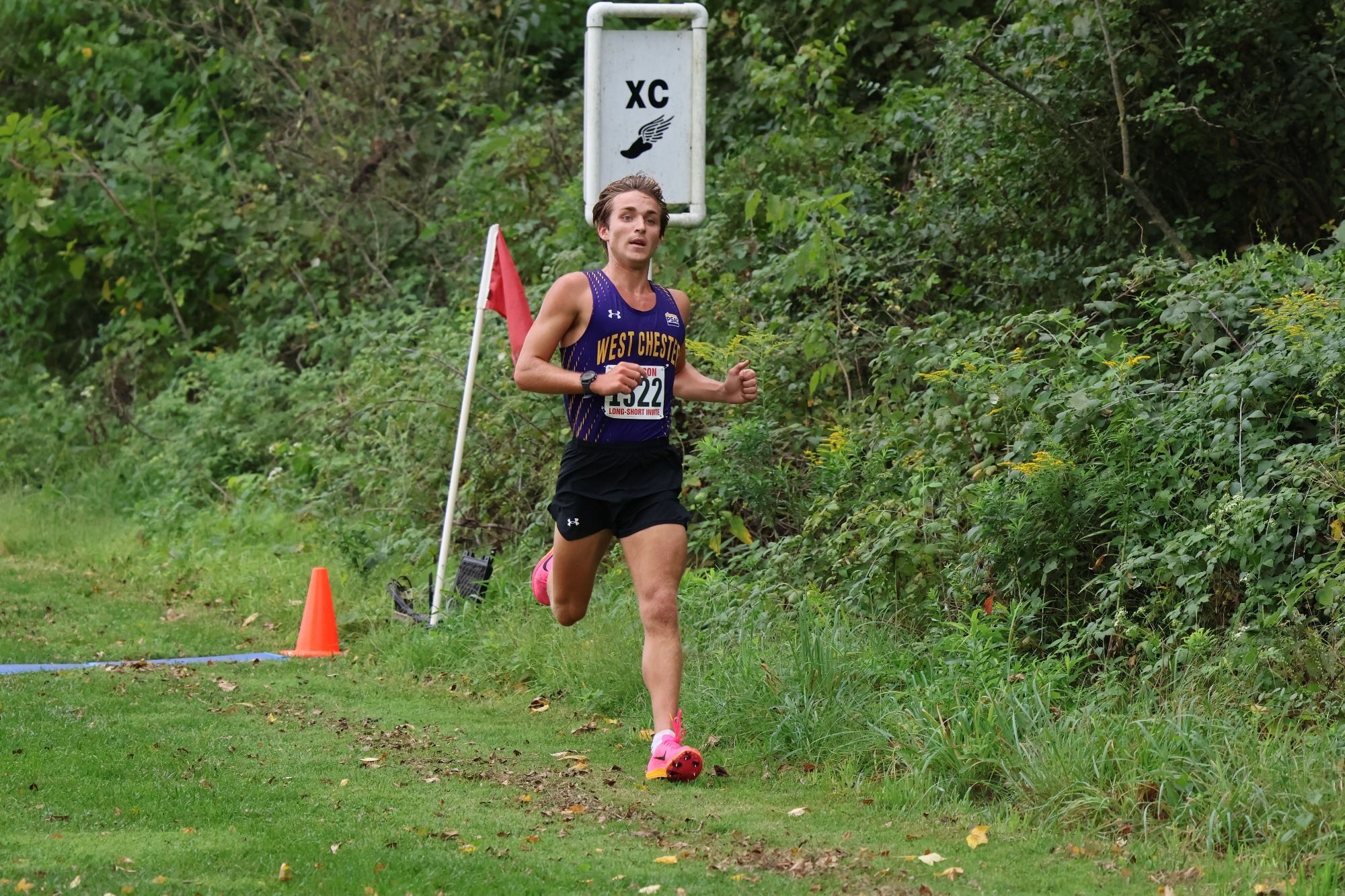 Matt Remishofski running down the hill at Dickinson Long-Short wearing purple racing top and timing bib that says 1322