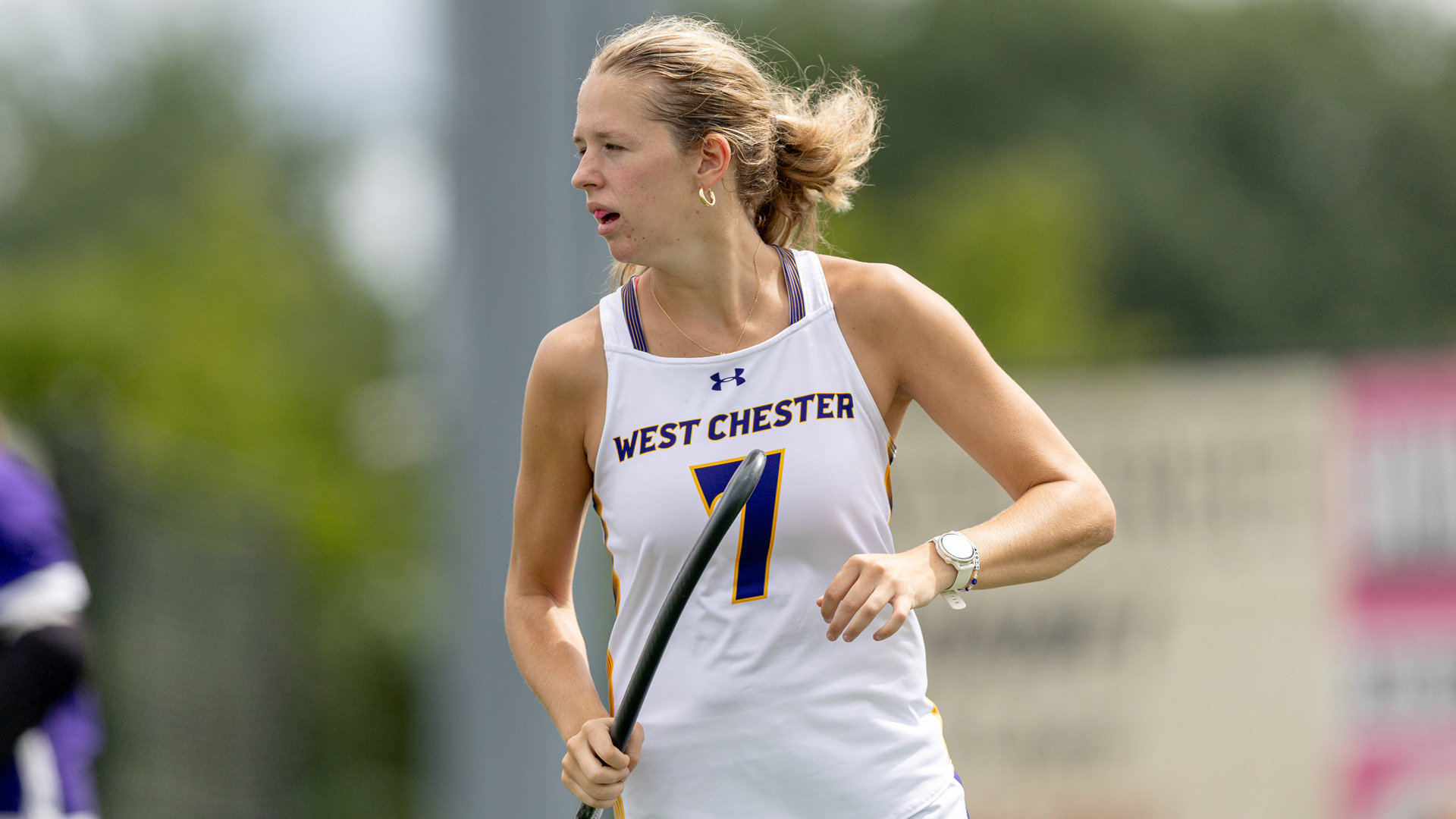 Lily Coombs runs up field in a win over Adelphi wearing West Chester's road white jersey