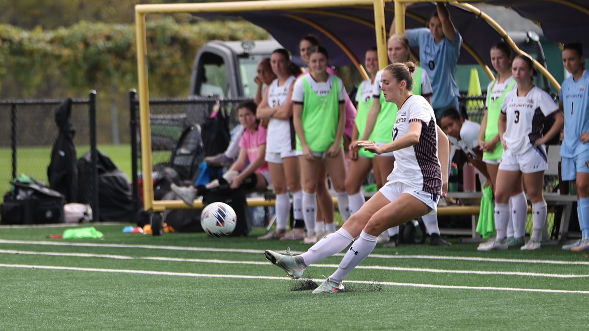 KATIE DOUGHERTY WEARING HOME UNIFORM TAKING A FREE KICK IN FROM OF WCU HOME BENCH THAT LED TO PENALTY KICK GOAL BY KIANNA BARBER VS ESU
