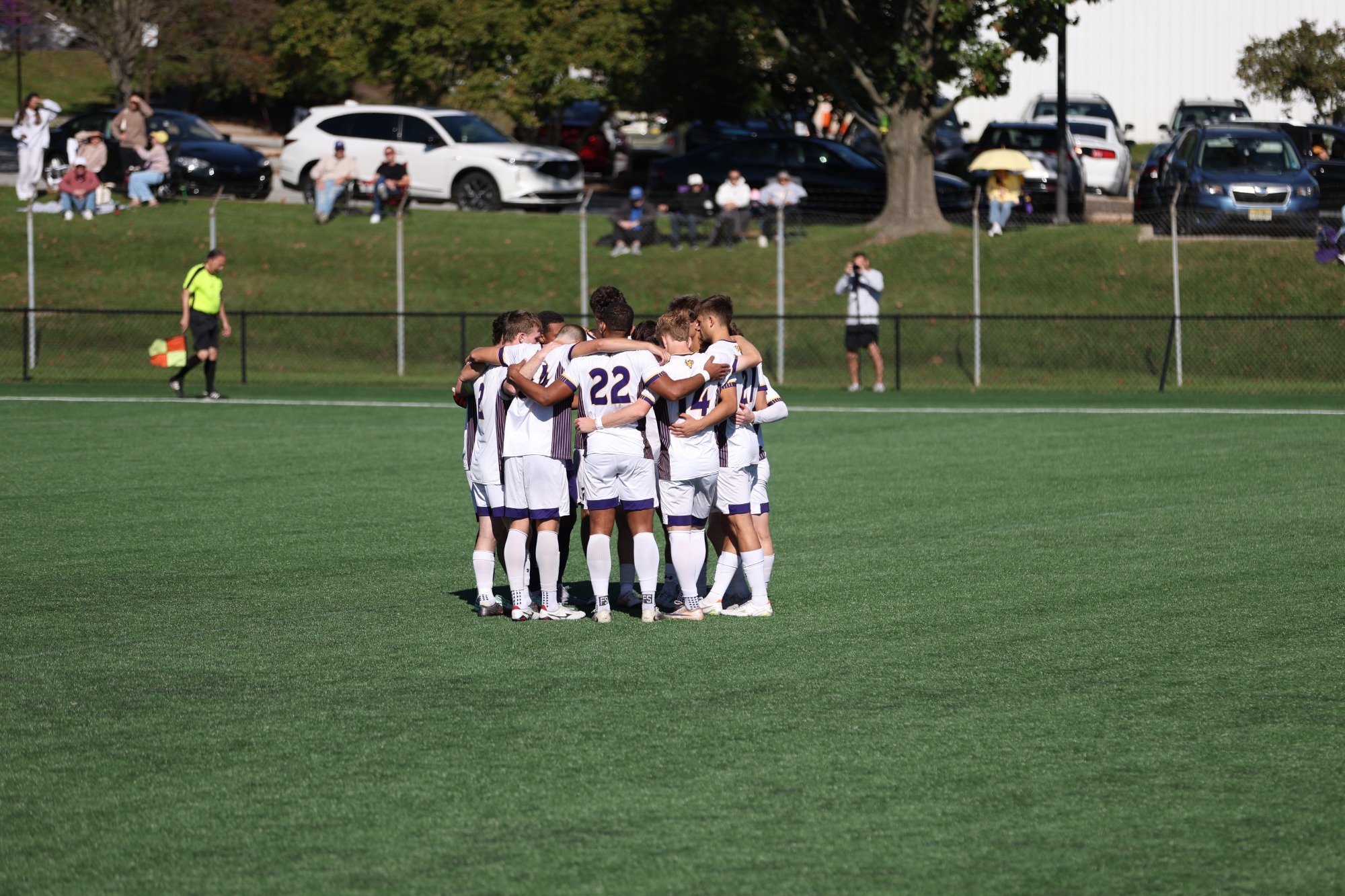 WCU MEN'S SOCCER TEAM WEARING HOME WHITE ON WHITE UNIFORMS WITH KEEPER IN ALL PURPLE HUDDLE ON FIELD PRIOR TO GAME VS MILLERSVILLE ON WEDNESDAY AFTERNOON