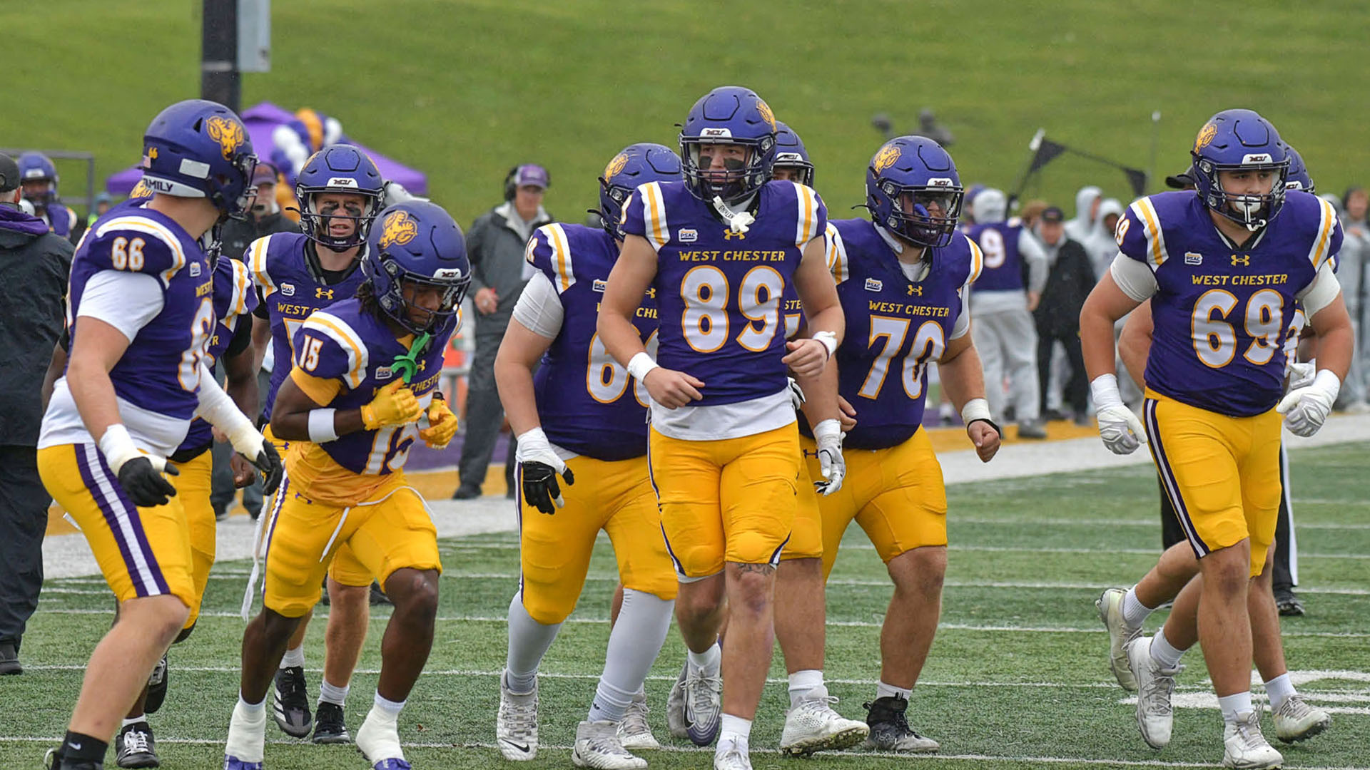 West Chester offense takes the field at home on Homecoming Weekend against Millersville in their purple uniforms with purple helmet and yellow pants