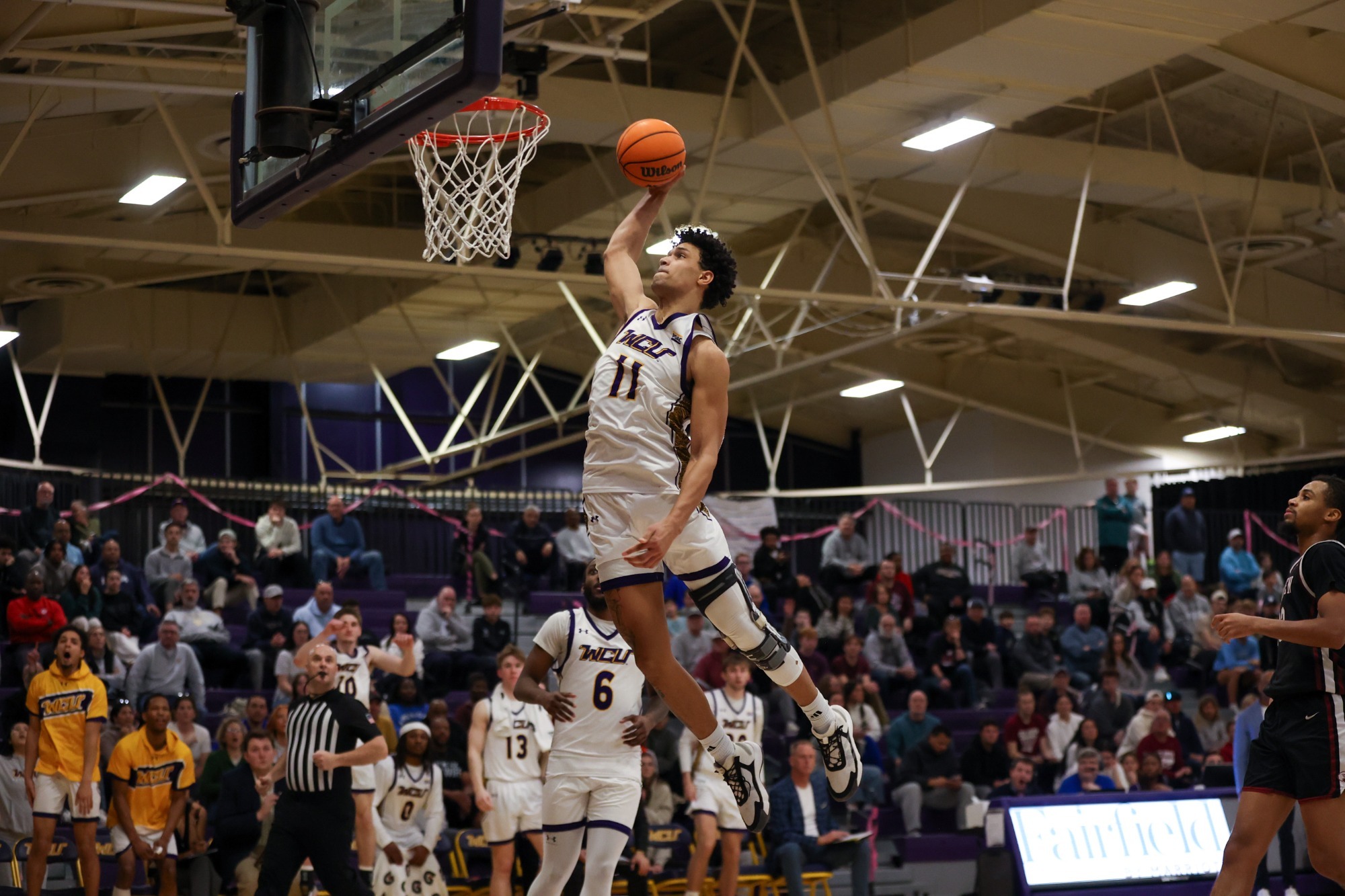 Gabe Moss in team issued home white uniform Dunking vs LHU on 2/21/26