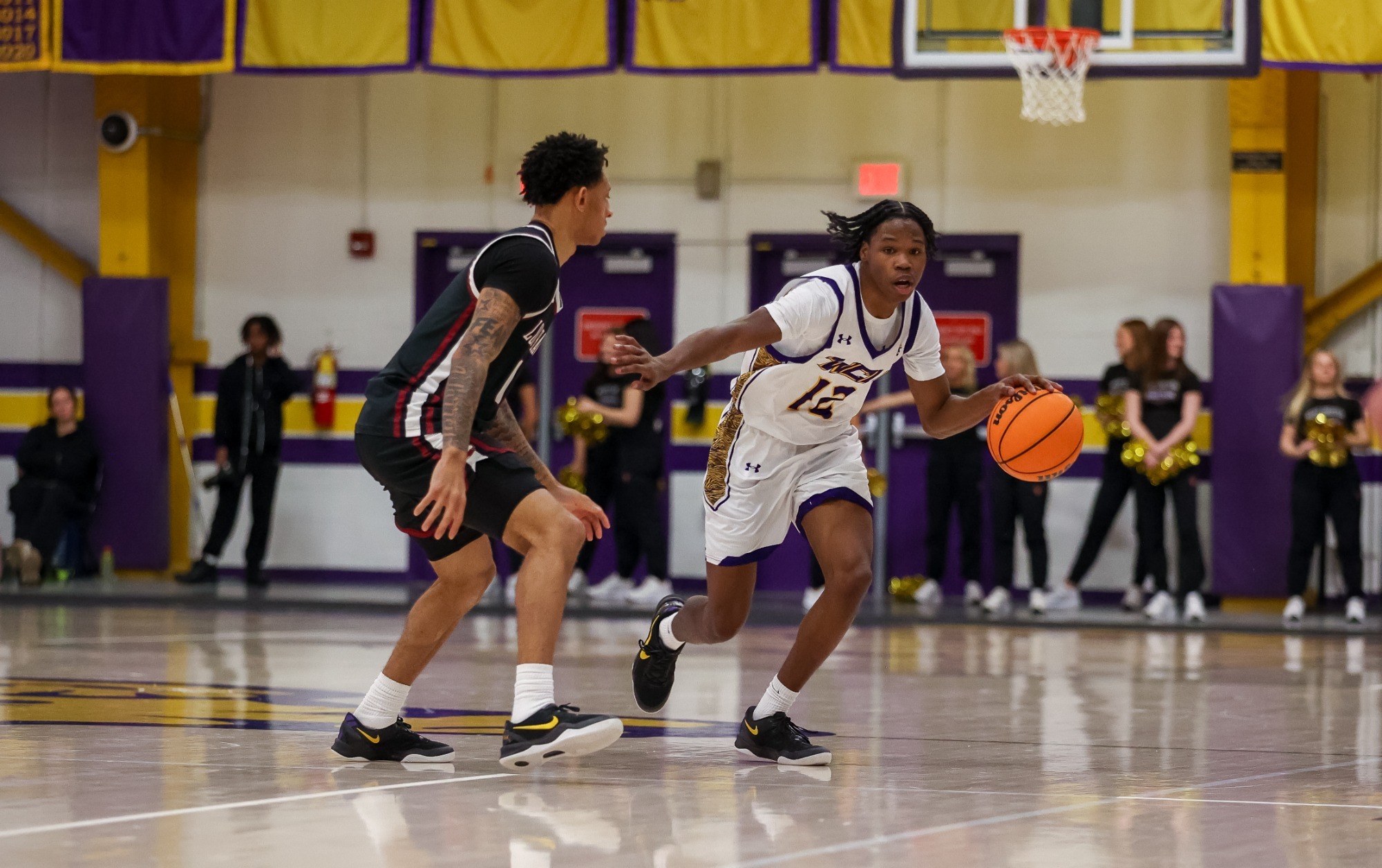 Jaysean Williams wearing home white uniform brings the ball up vs Lock Haven on 2-21-26