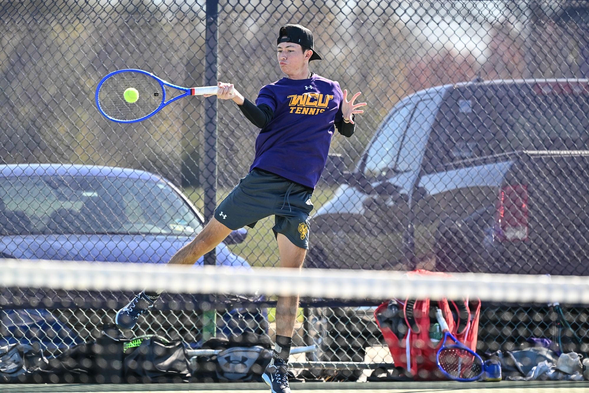 Men's Tennis player against St. Thomas Aquinas wearing purple shirt and gray shorts on 10-21-25