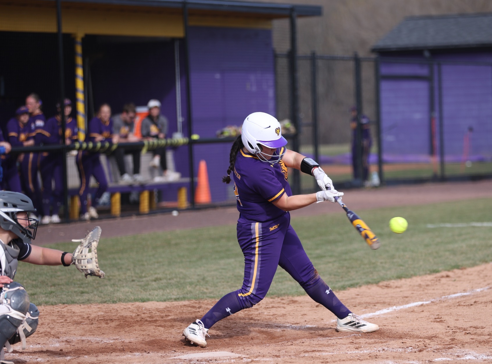 Ceara O'Neal hits one of her two home runs on Saturday against Lock Haven wearing new purple home uniforms