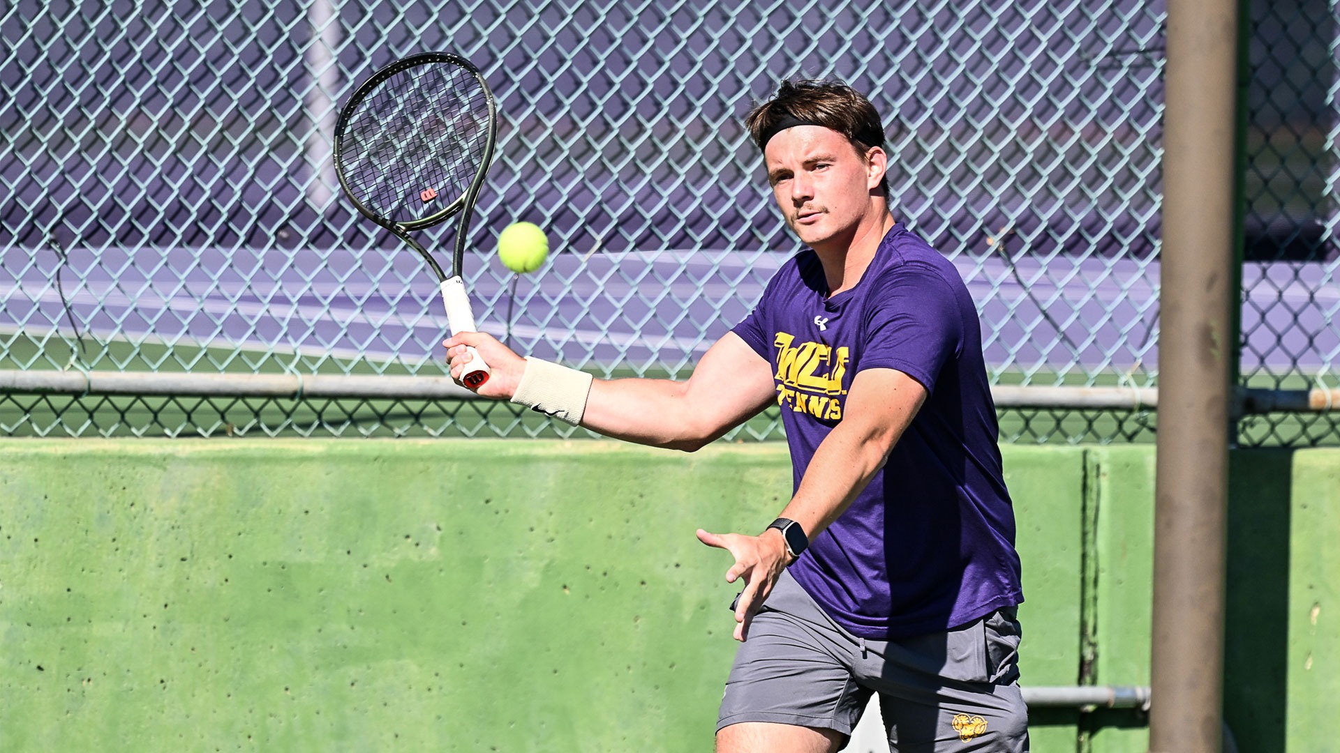 men's tennis player wearing purple shirt and gray shorts playing vs STAC in October 2025